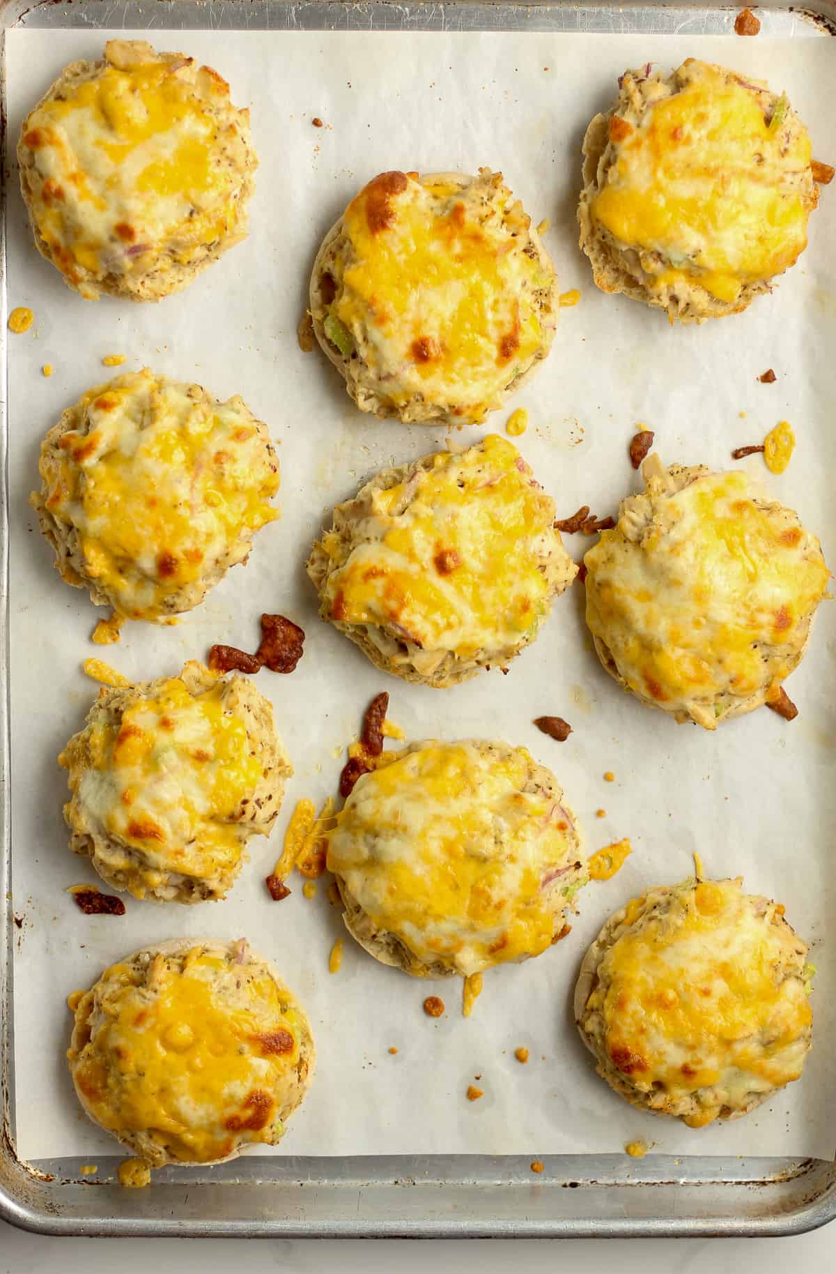 A pan of the baked tuna melts with cheddar cheese.