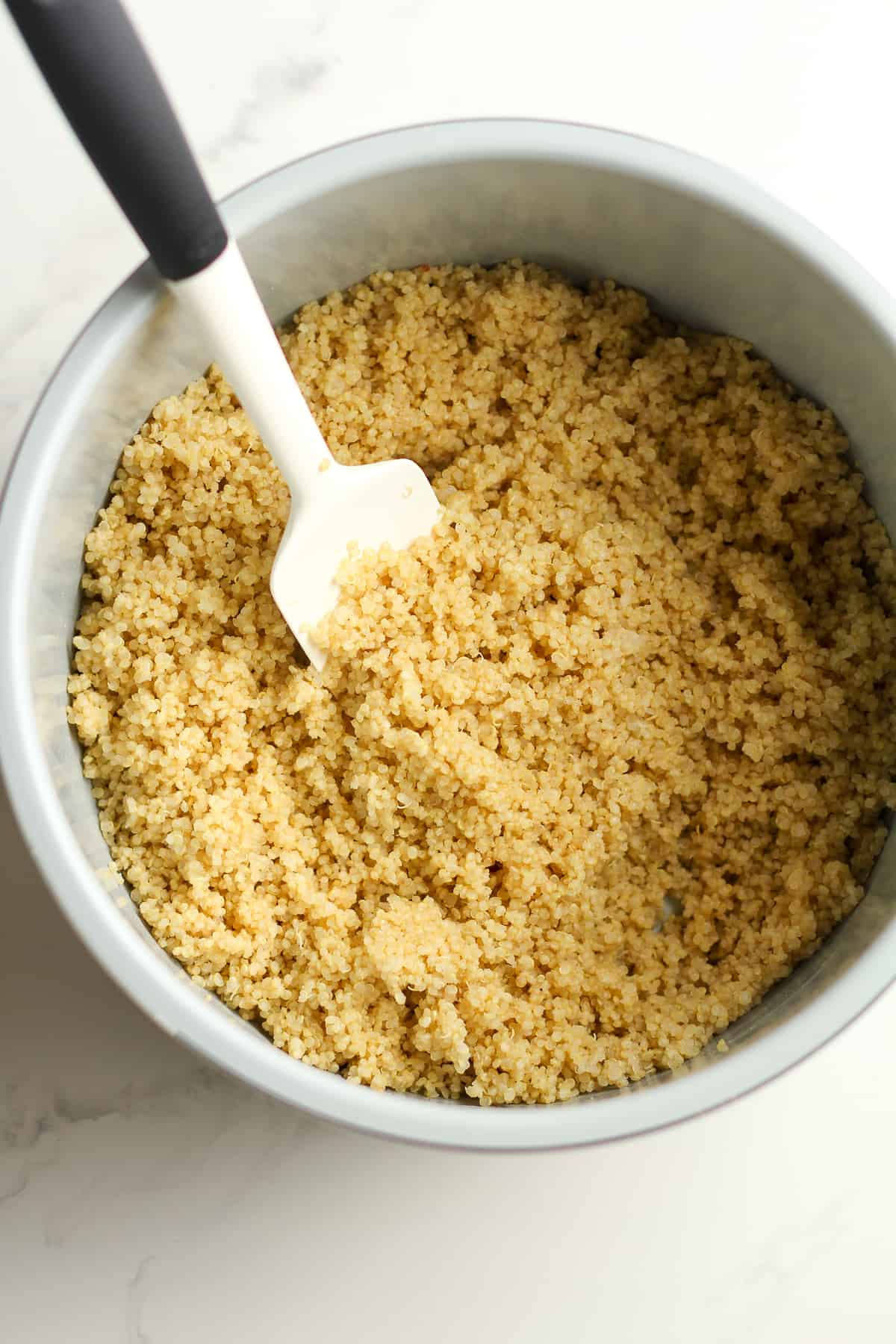 An instant pot with the cooked quinoa.