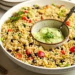 A large bowl of the Mexican quinoa salad with a smaller boil of quinoa