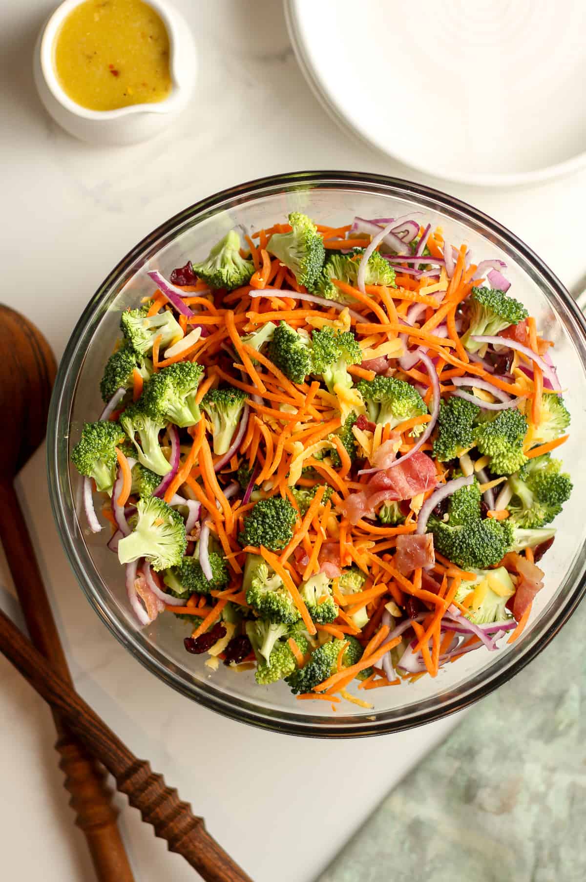 A glass bowl of the broccoli salad before adding the dressing.