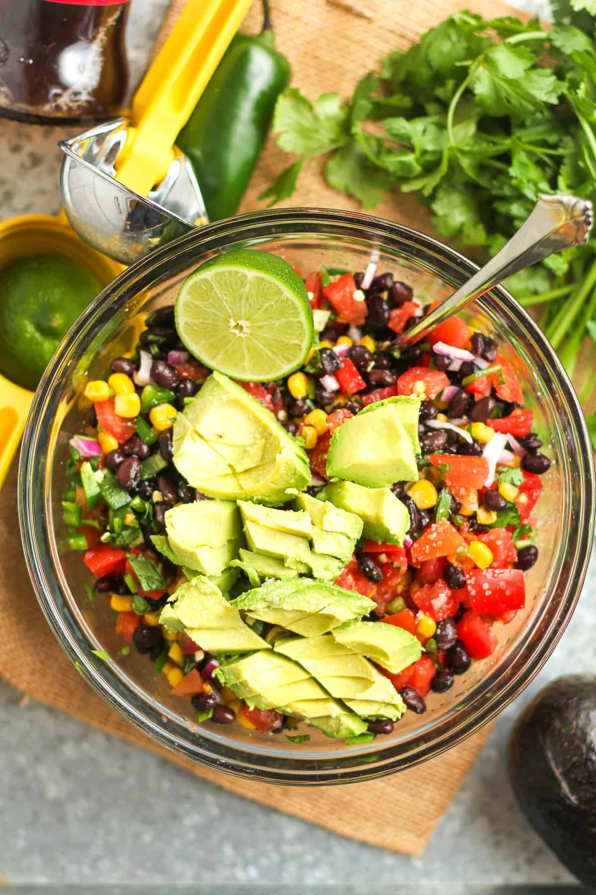 A bowl of the cowboy caviar, with the diced avocado on top.