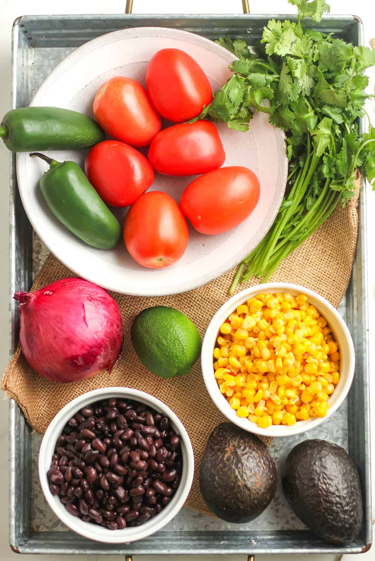 A tray of all of the ingredients for cowboy caviar.
