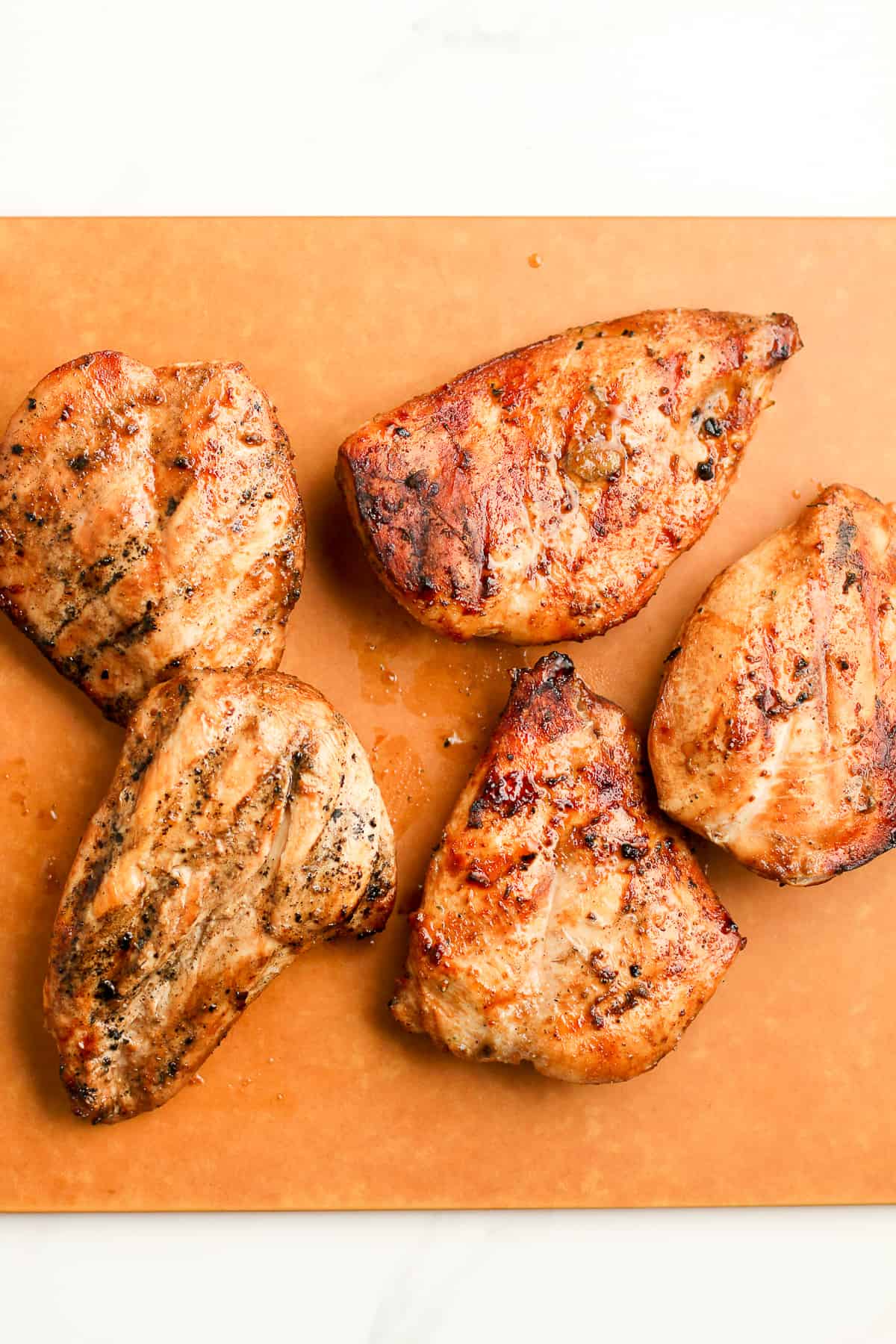A board of the grilled chicken breasts.