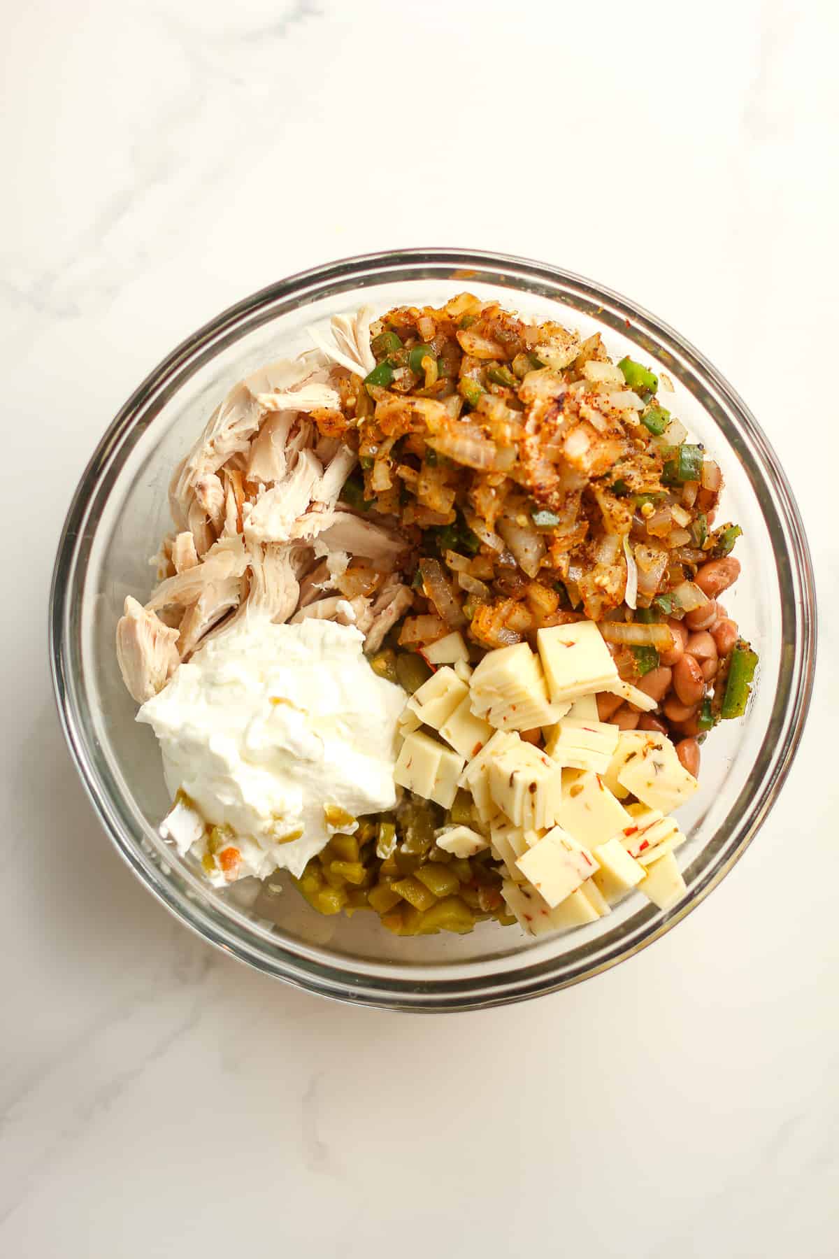 A bowl of the chicken, veggies, Greek yogurt, green chilies, beans, and cheese.