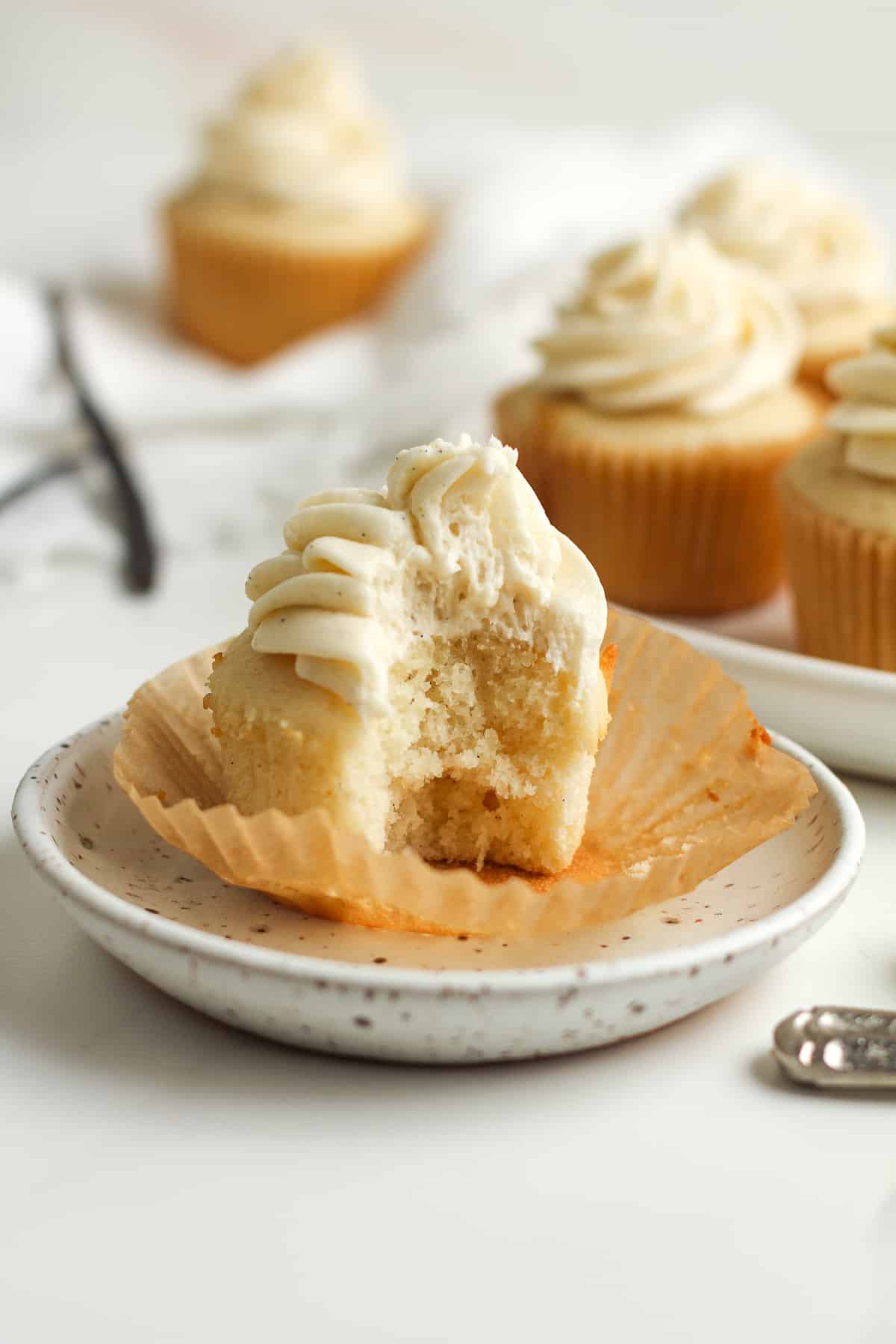 Side view of a cupcake with a huge bite out.