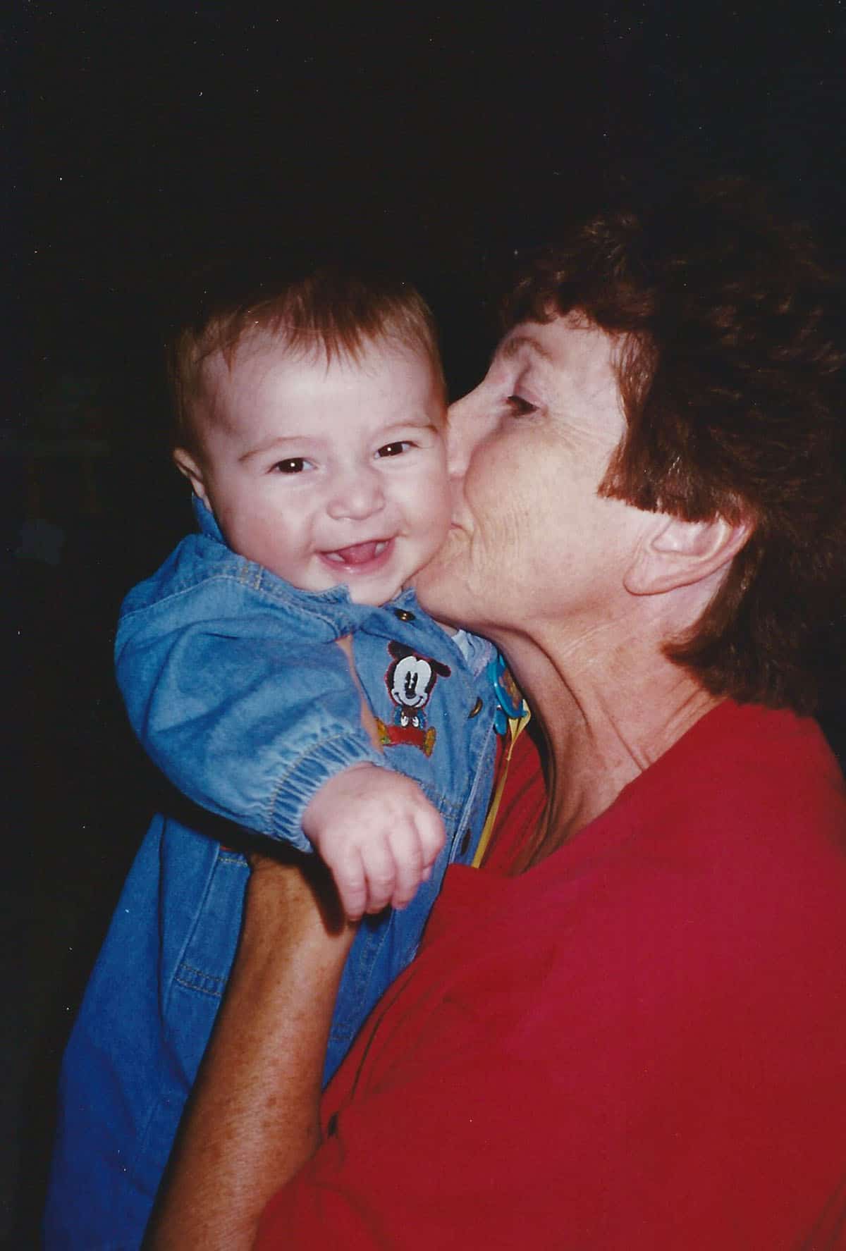 Mom kissing Josh when he was a baby.