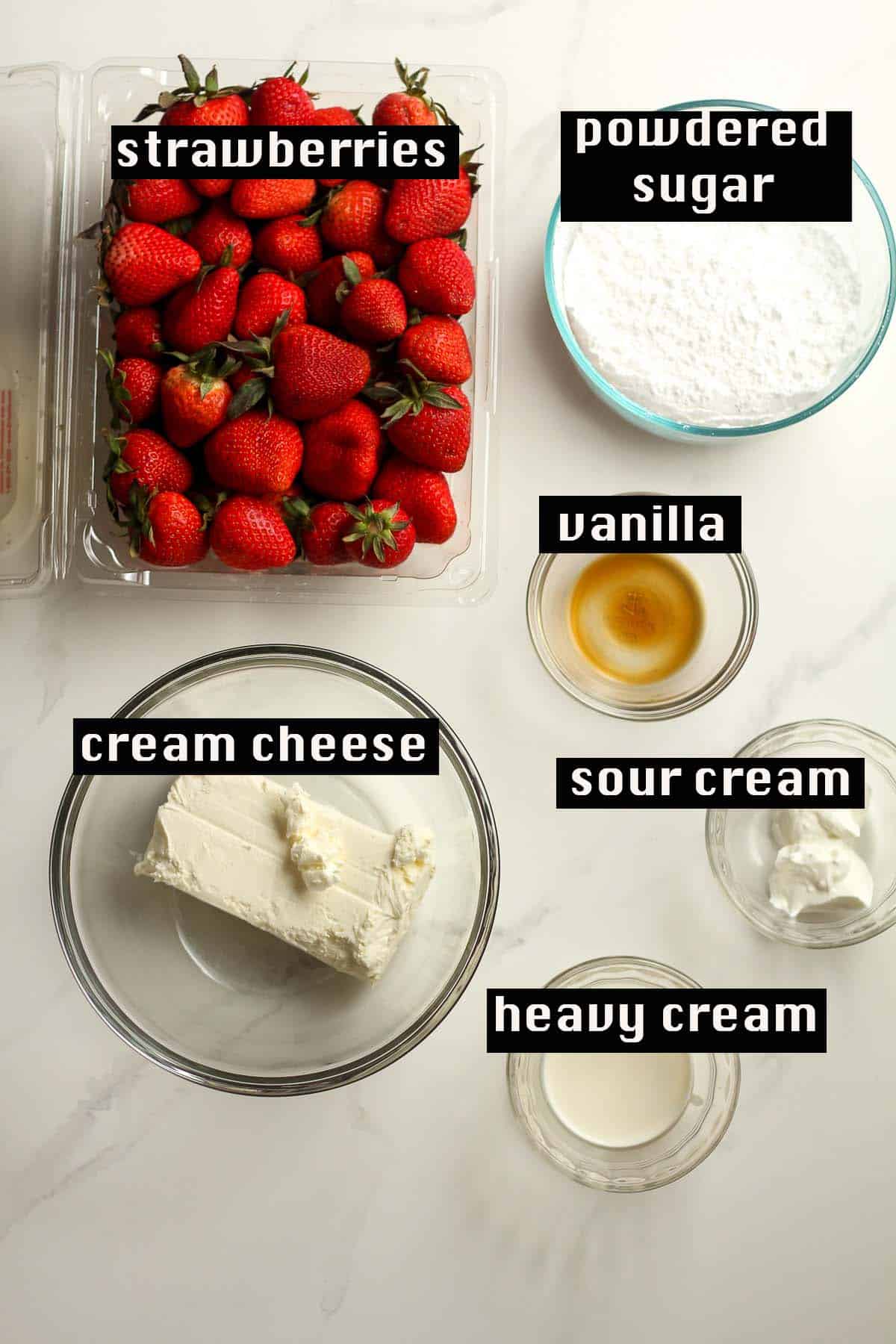 The ingredients for the strawberry cheesecake bites, on a white background.