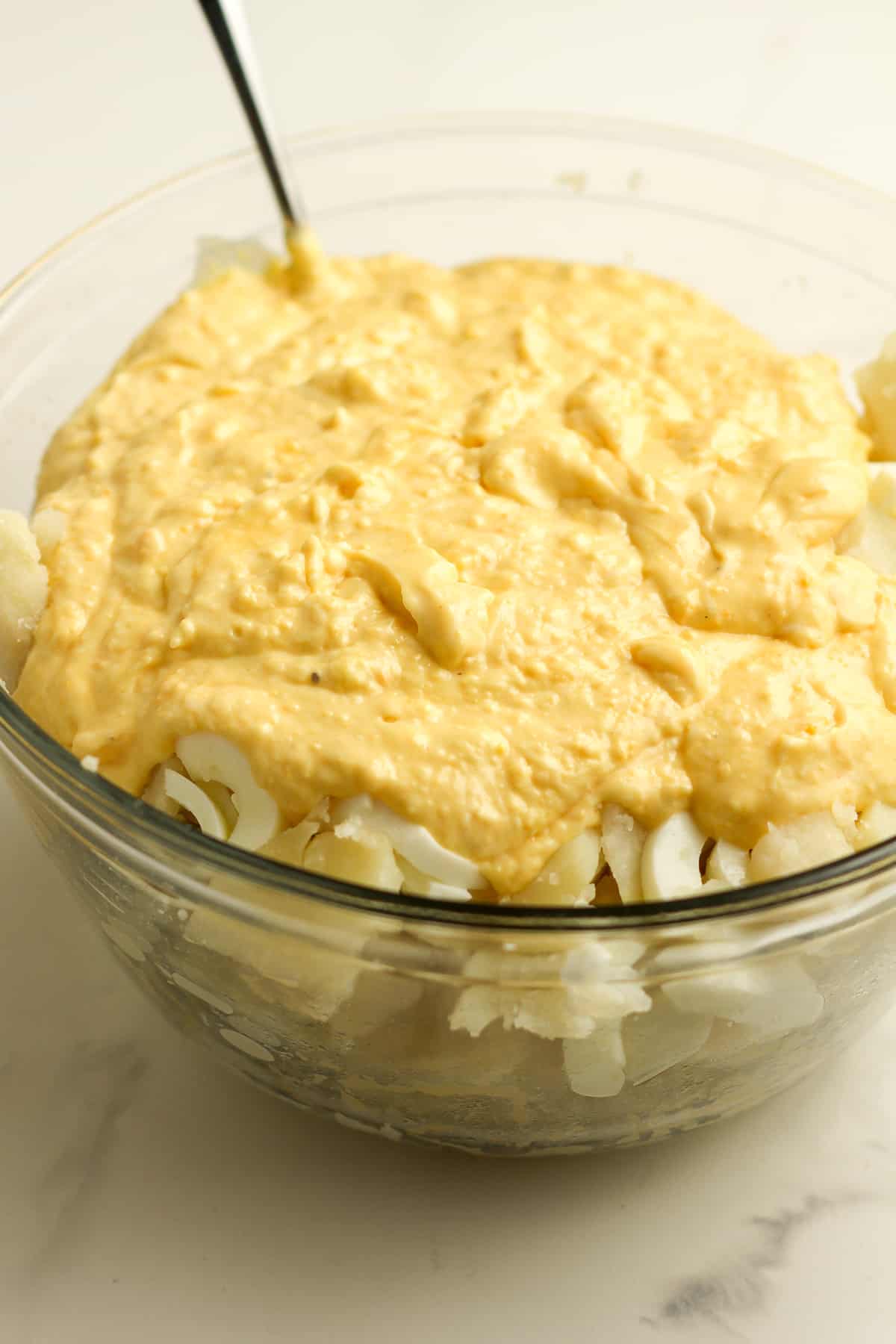 Side view of the potato salad before mixing together.