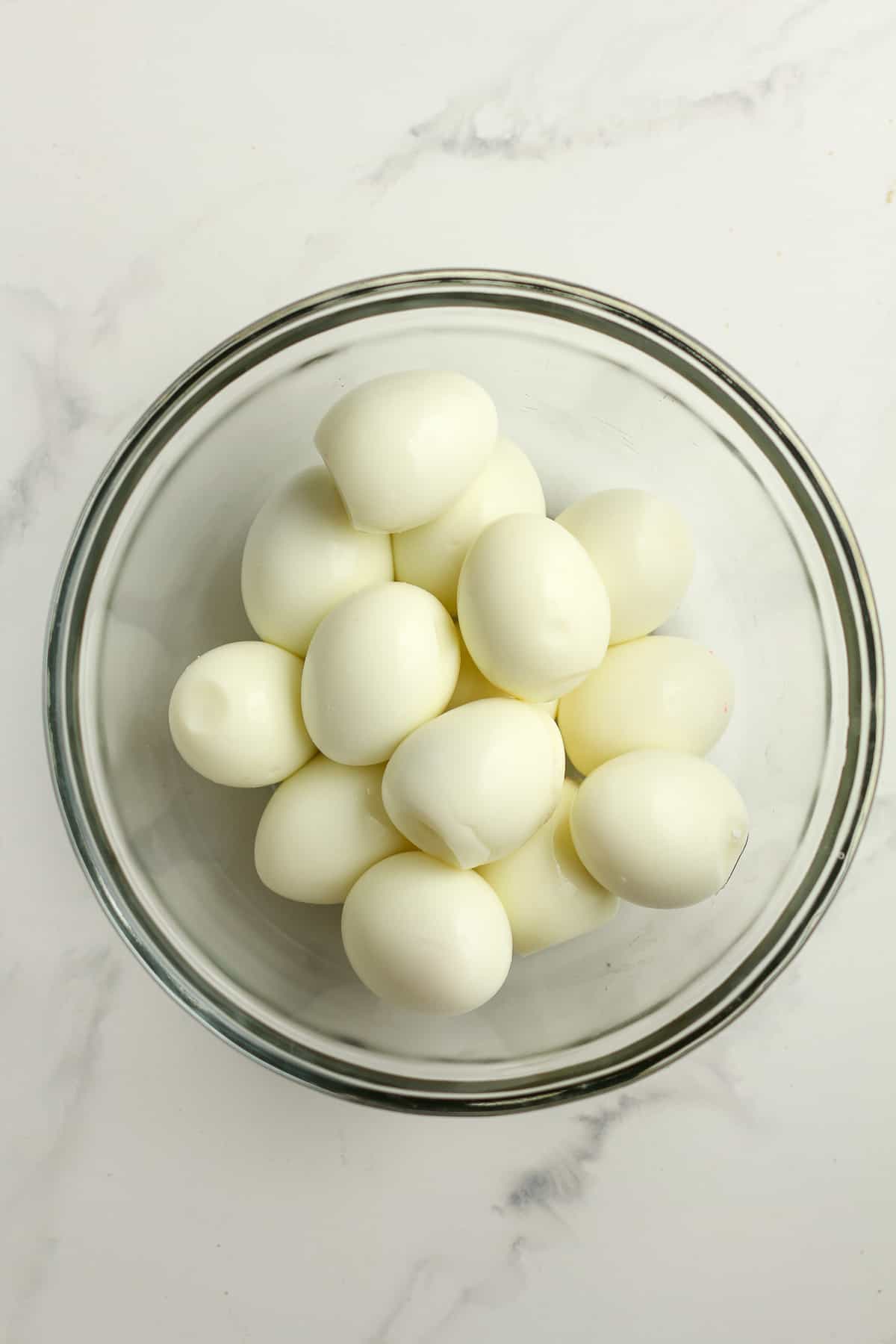 A bowl of cooked hard boiled eggs.