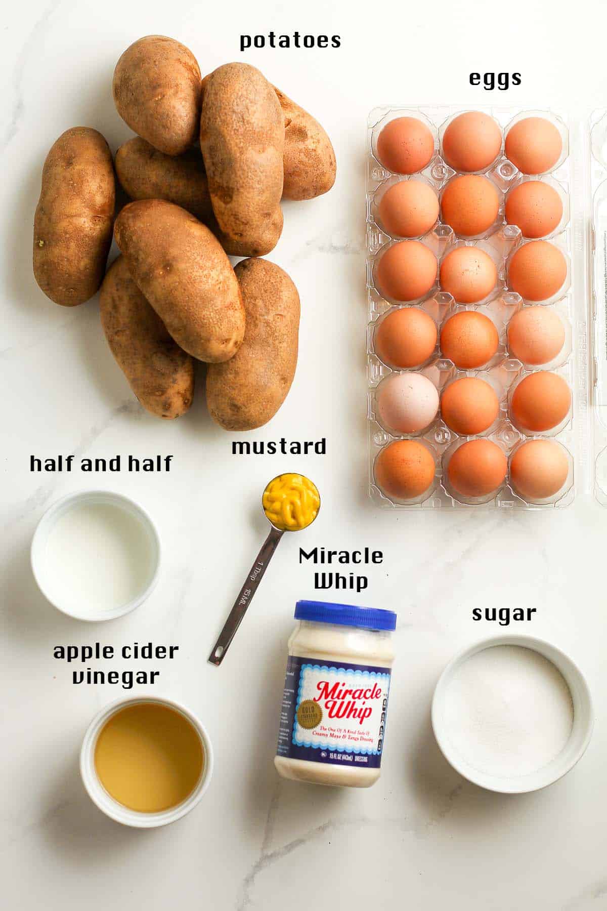 All of the potato salad ingredients on a white background.