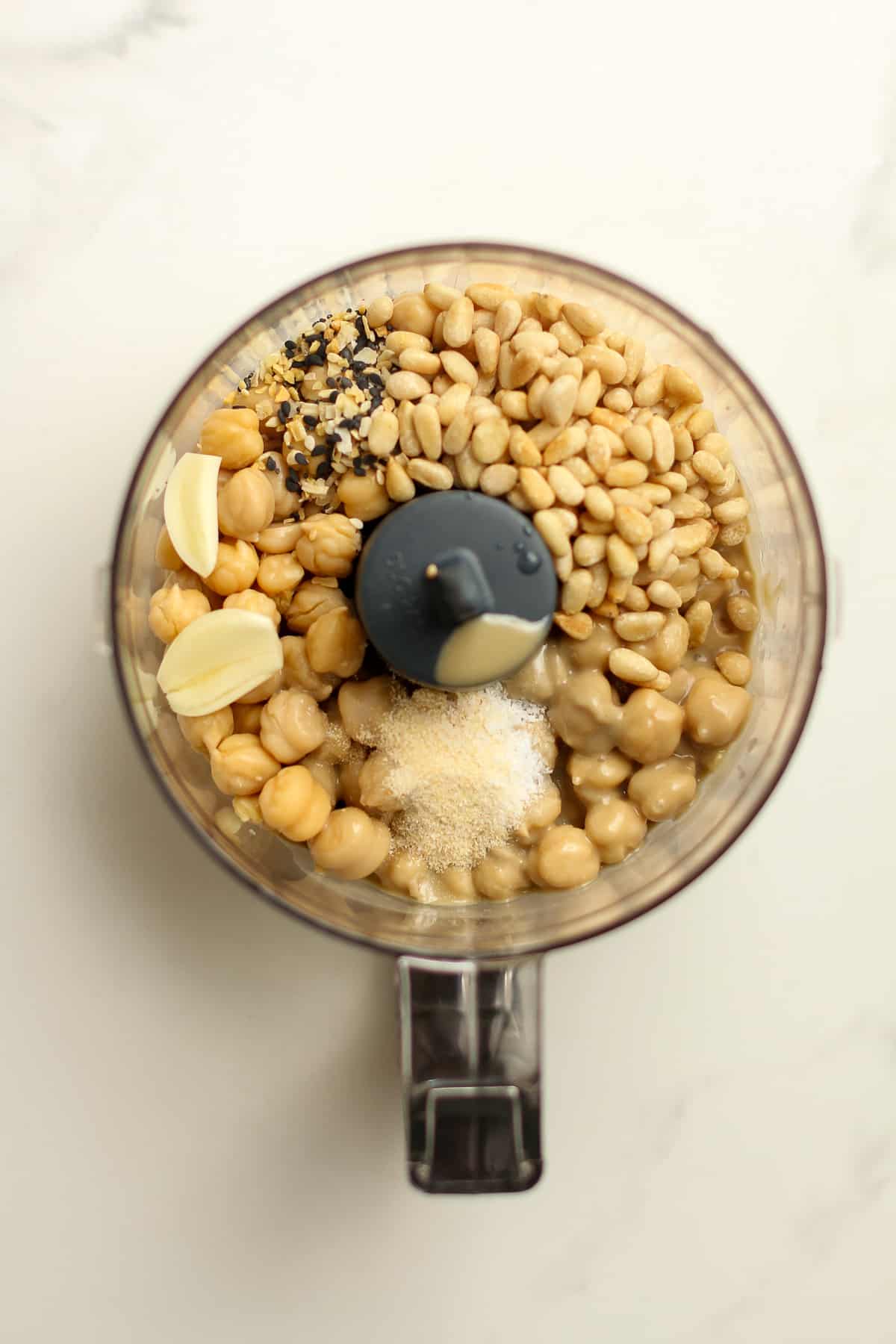 The hummus ingredients in a food processor before blending.