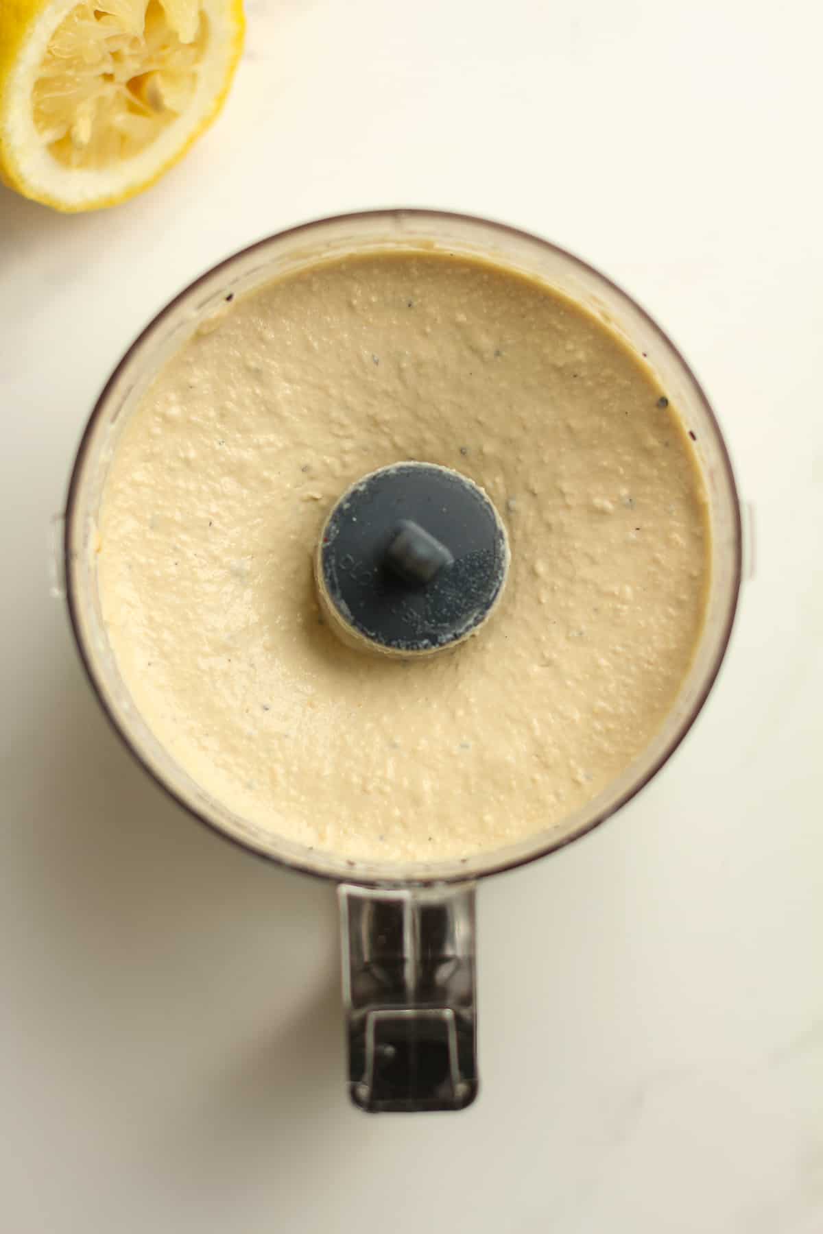 The blended hummus in a small food processor.