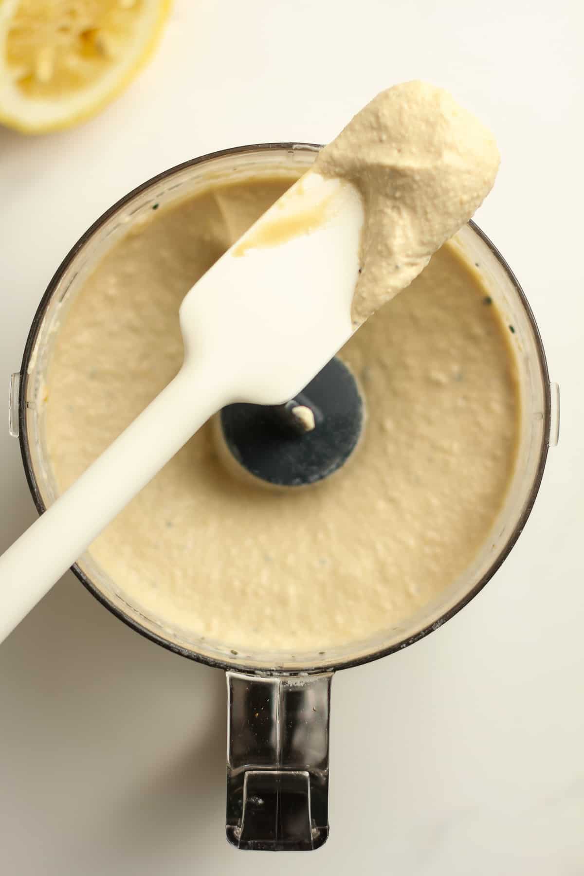 A spatula on top of a mini food processor showing how creamy it is.