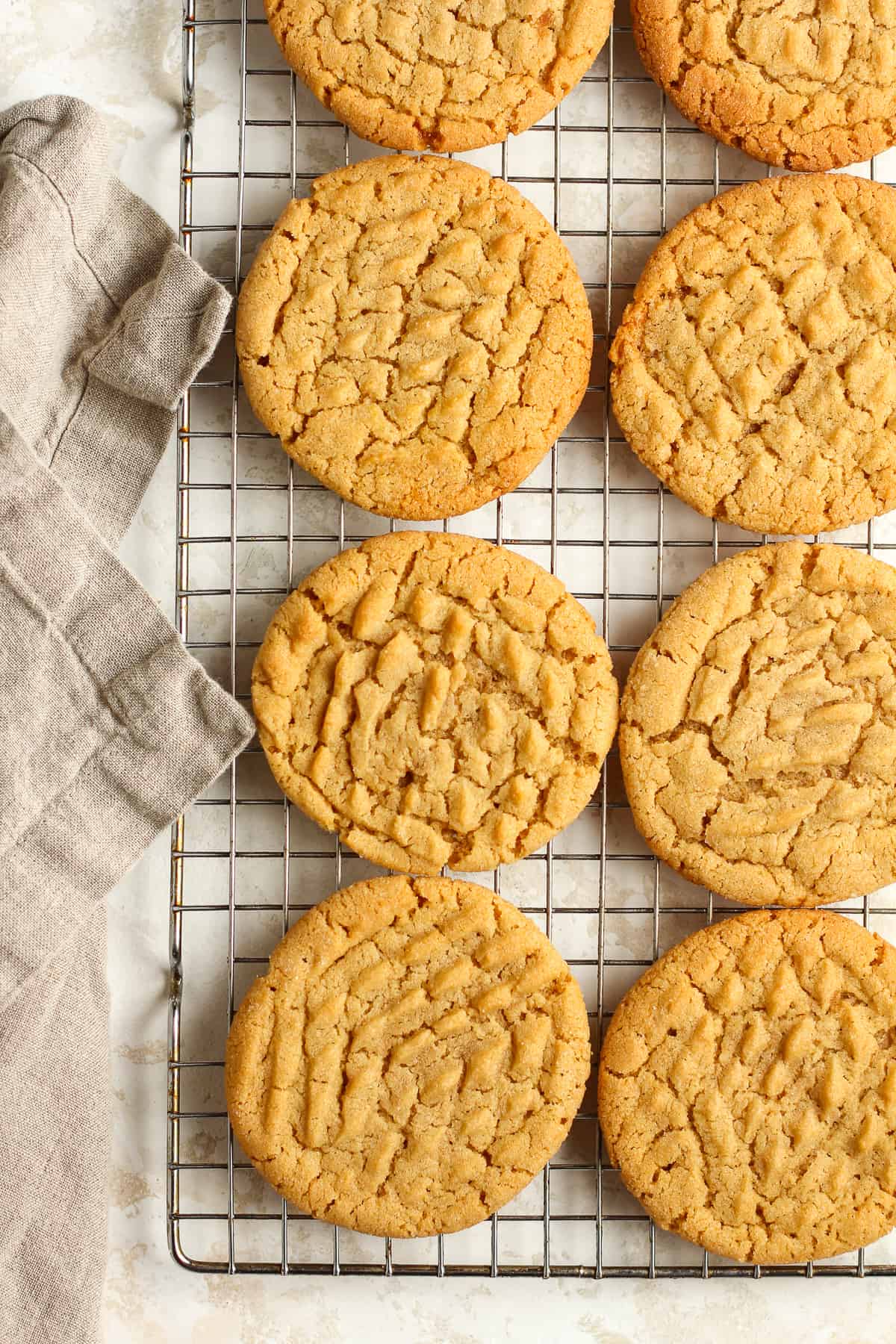 Closeup of eight peanut butter cookies on a cooling rack.