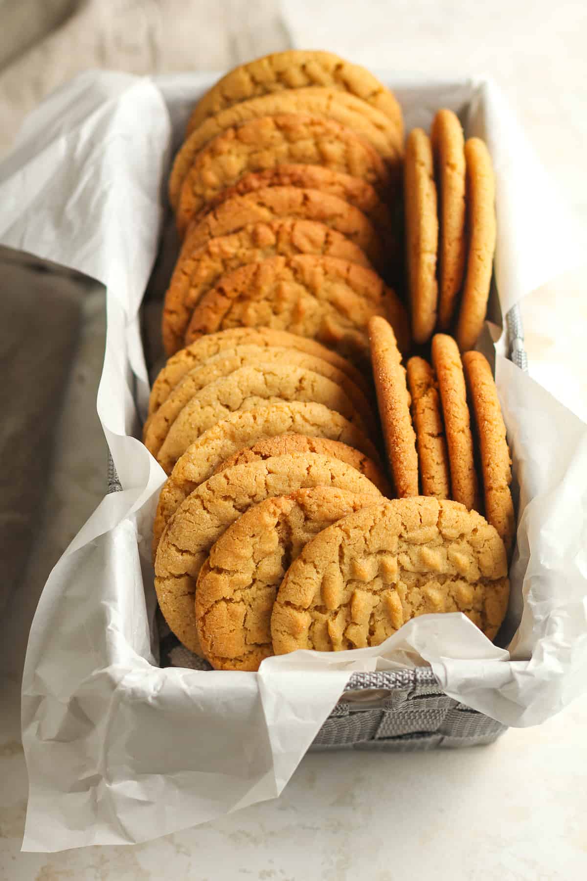 Side view of a rectangular basket of peanut butter cookies.