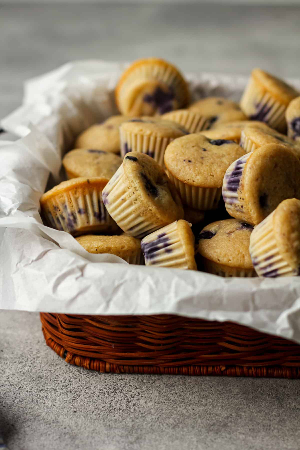 Side shot of a basket of mini muffins.