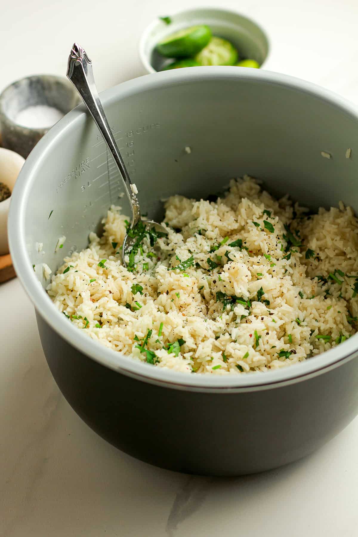 Side view of an instant pot full of cilantro lime rice.
