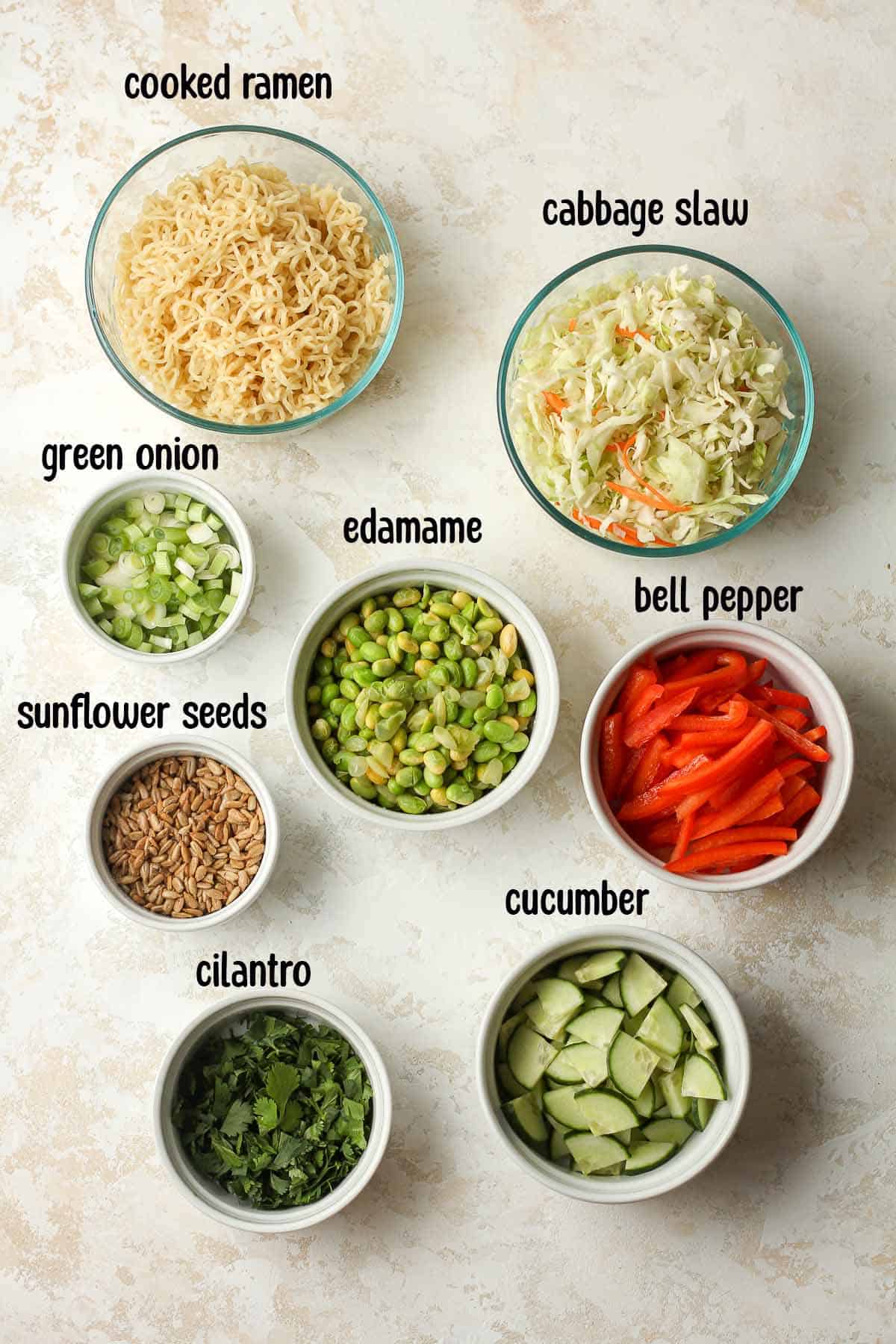 Ingredients for cold ramen salad, in individual bowls.
