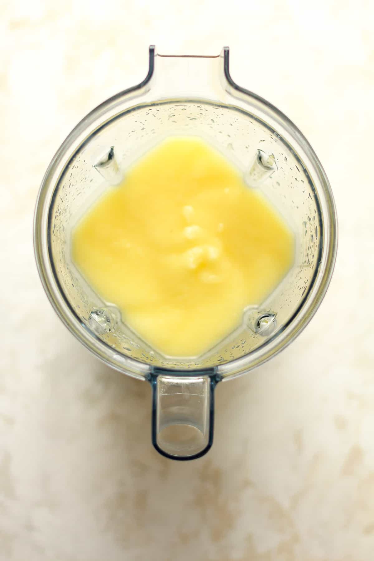 A blender of frozen margaritas with pineapple.