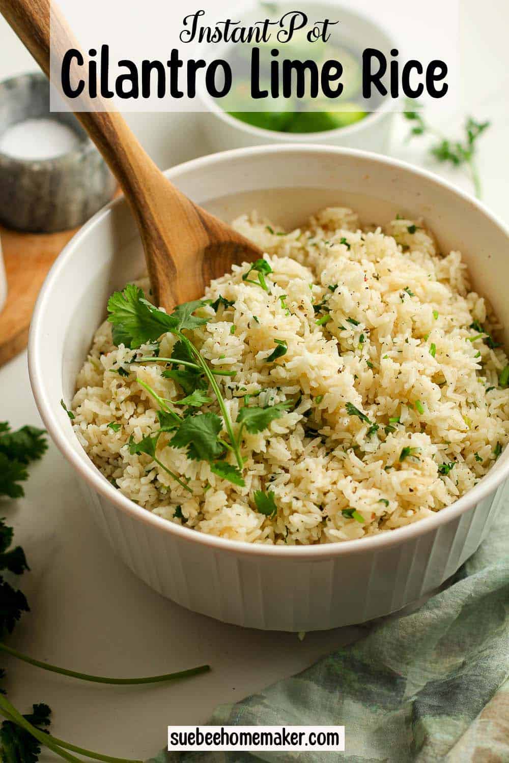 A bowl of cilantro lime rice with a wooden spoon.