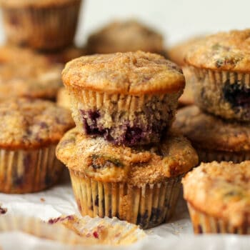 A tray of stacked lemon blueberry streusel muffins.