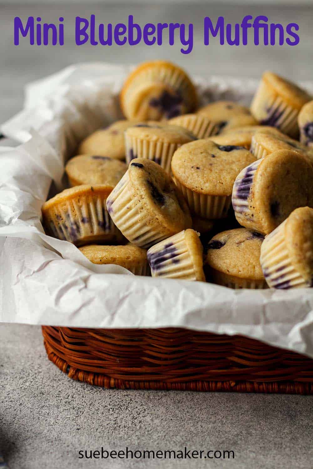 A basket of mini blueberry muffins.