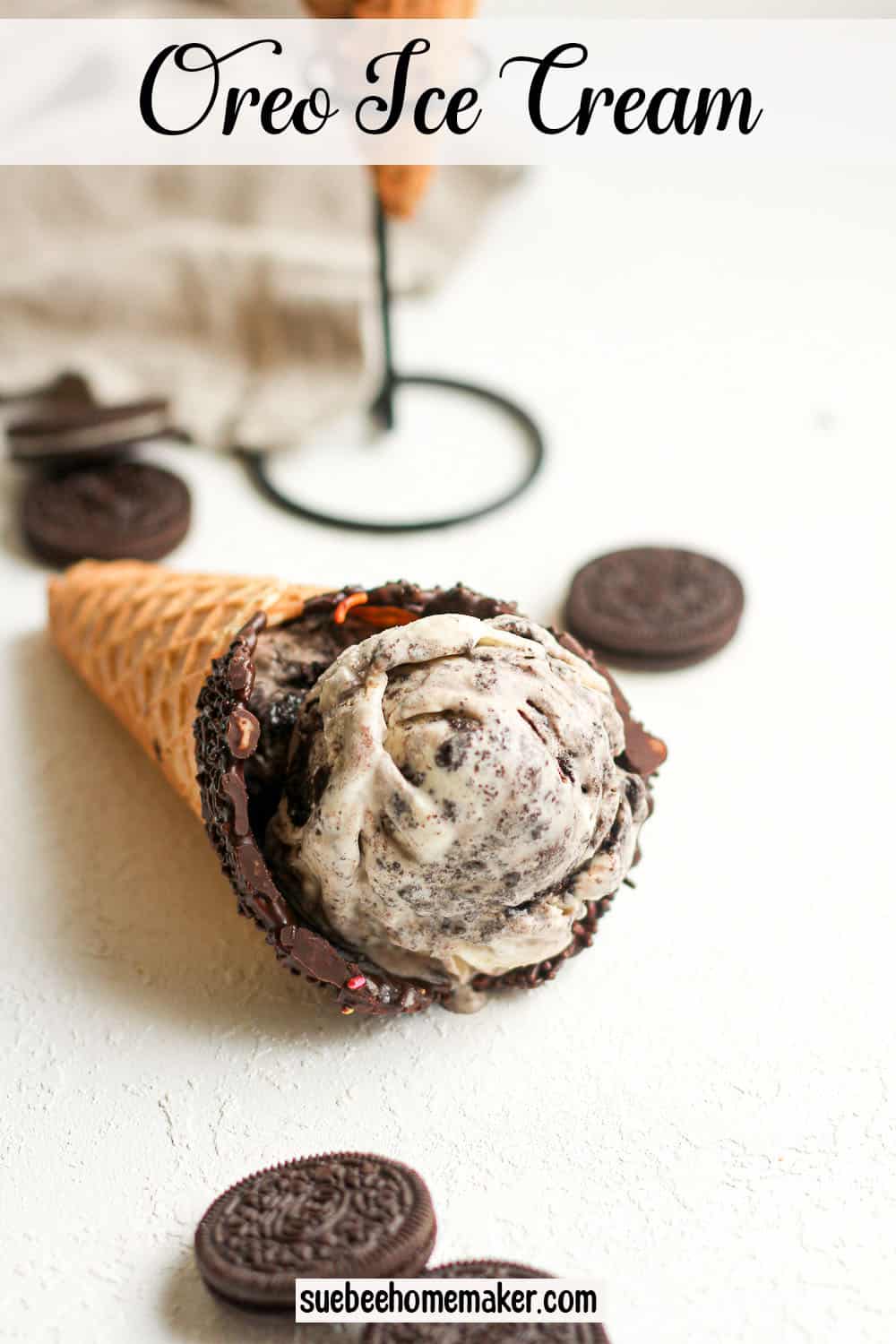 An Oreo ice cream cone laying on the white surface.
