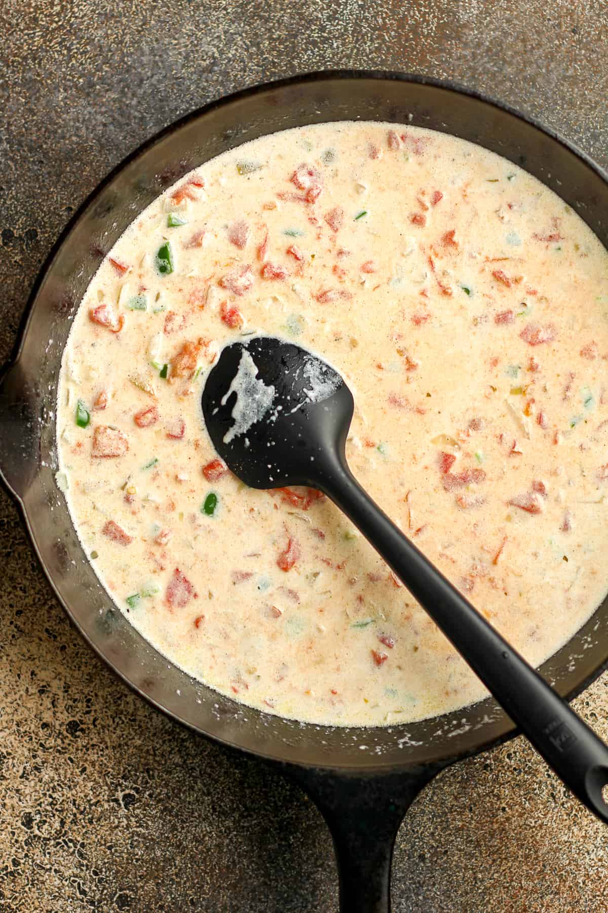 A skillet of the liquid queso before adding the cheese.