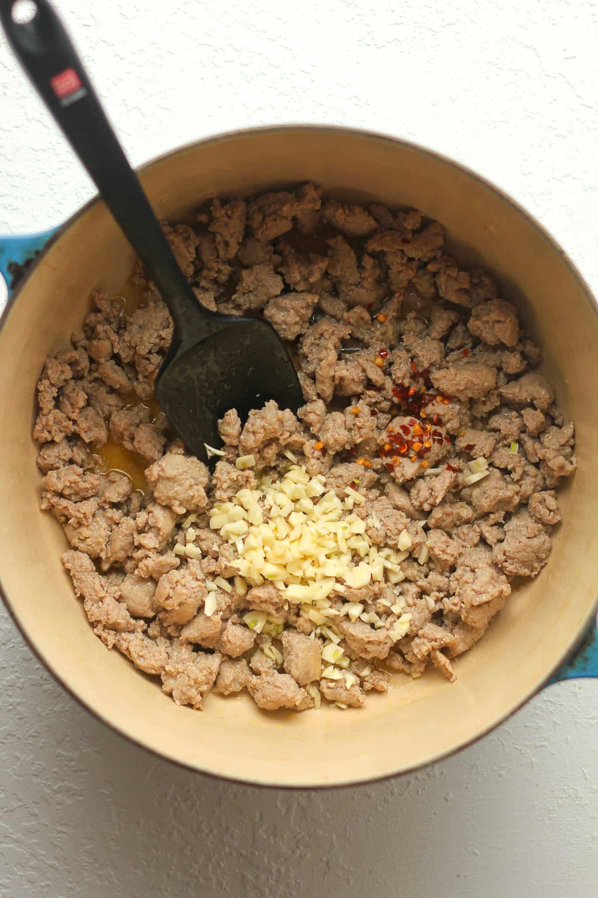 A pot of the cooked turkey sausage with garlic and seasoning on top.