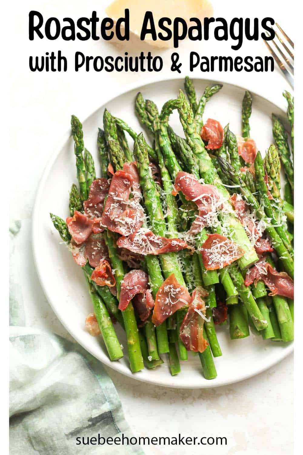 A plate of roasted asparagus with prosciutto and parmesan cheese.