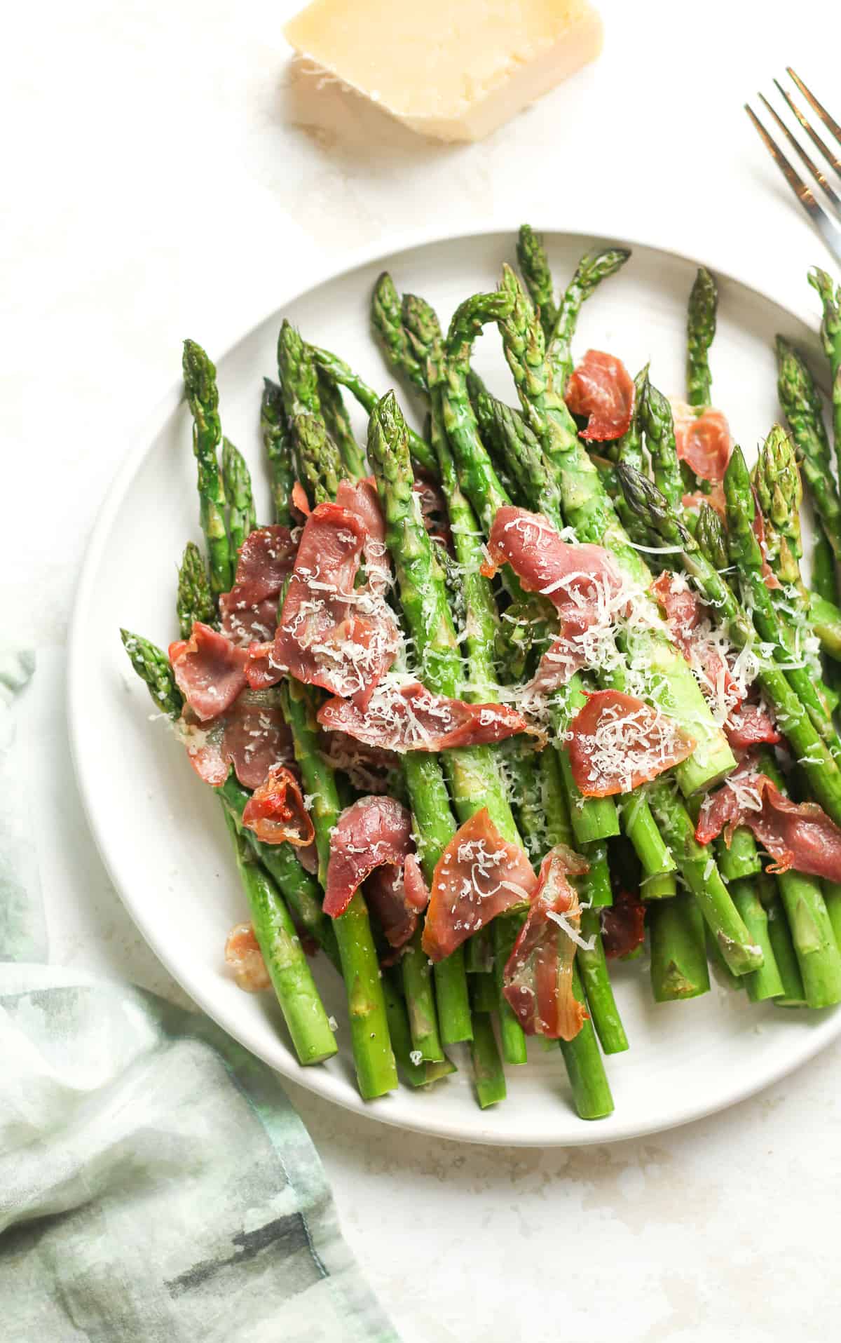 Closeup on a plate of roasted asparagus.