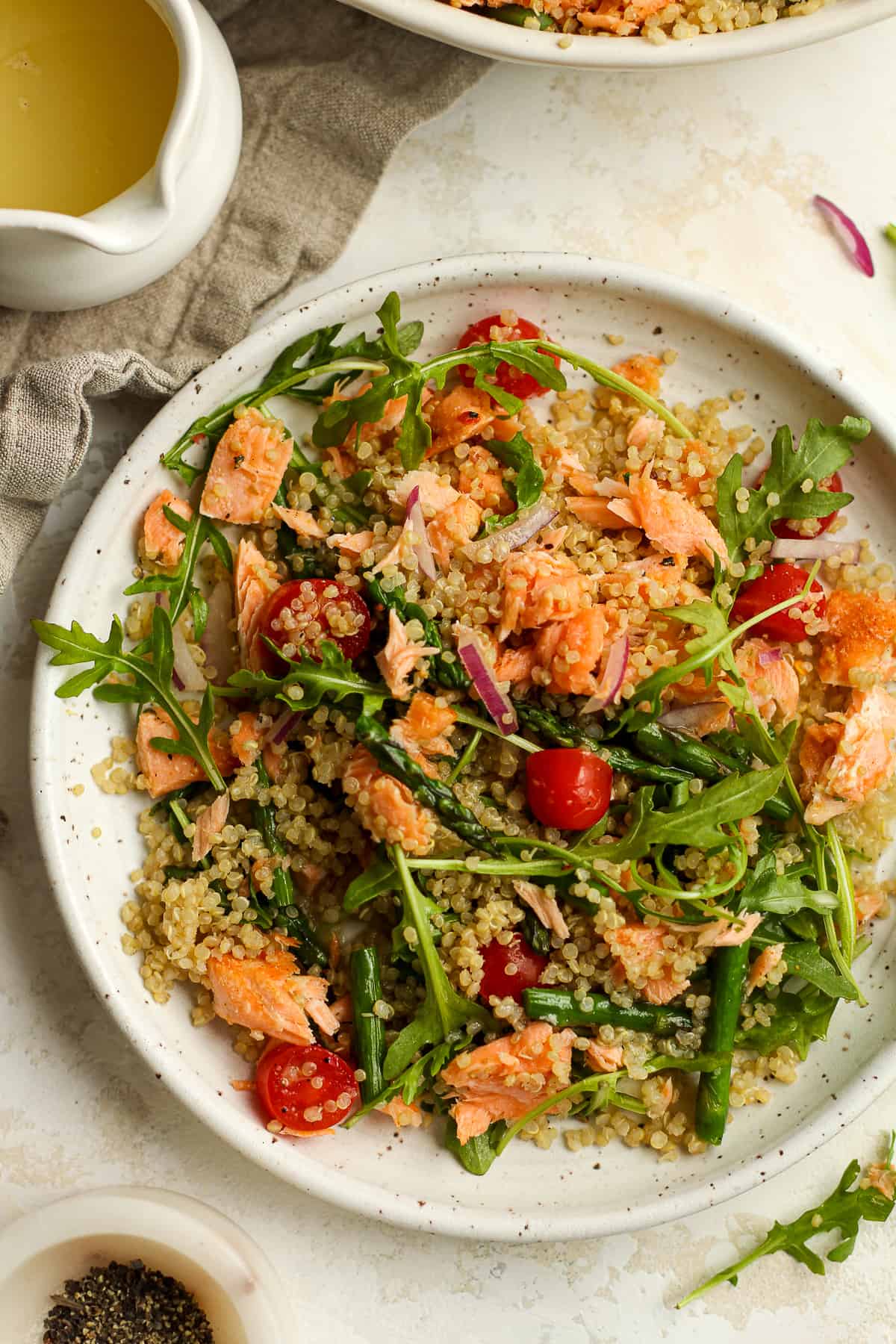 A serving plate of quinoa salad with leftover salad.