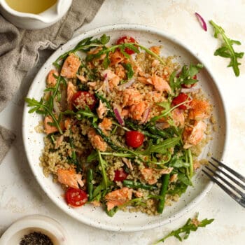 Overhead shot of a serving plate of salmon quinoa salad with lemon dressing.