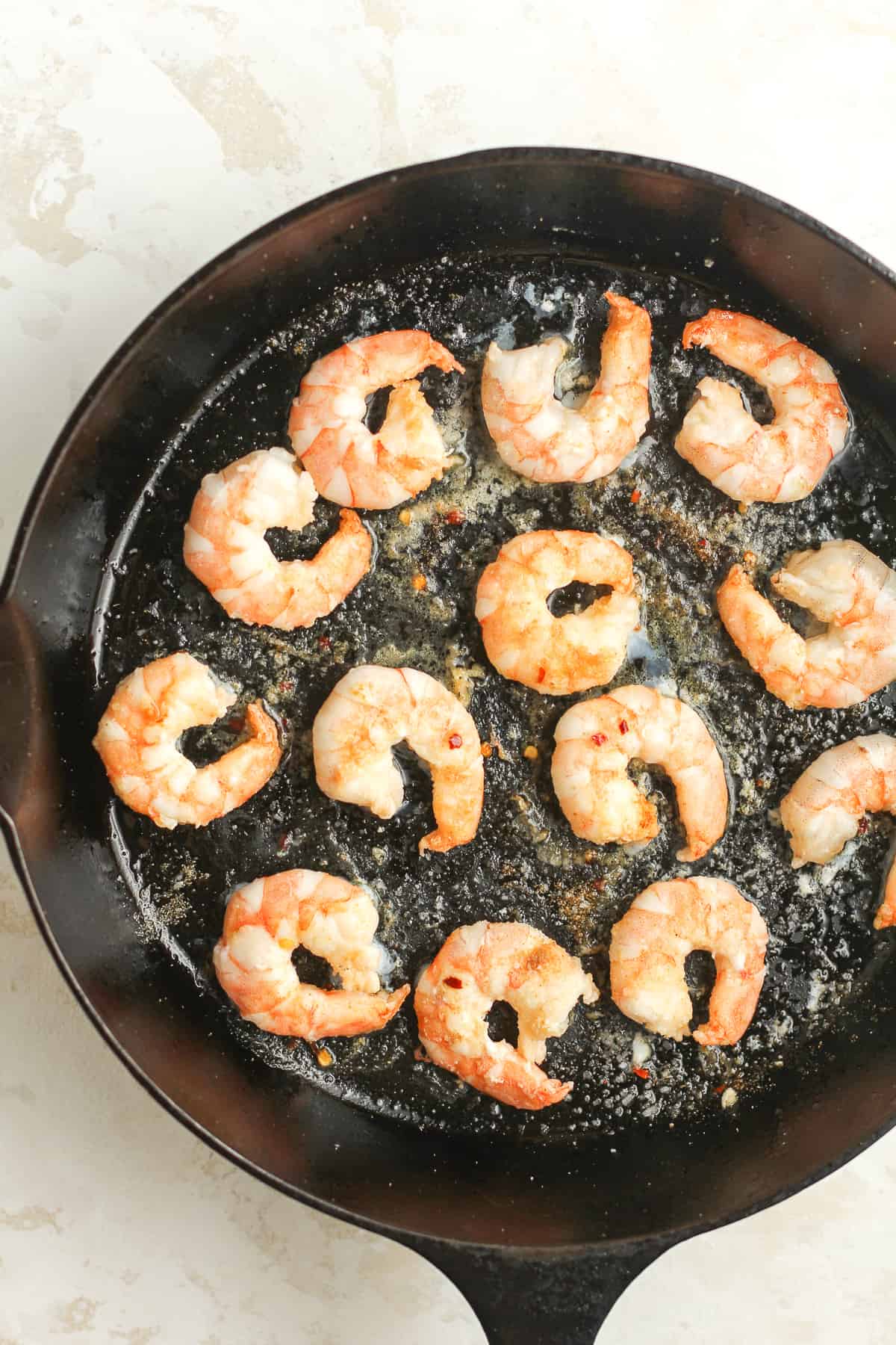 A cast iron with the cooked shrimp.