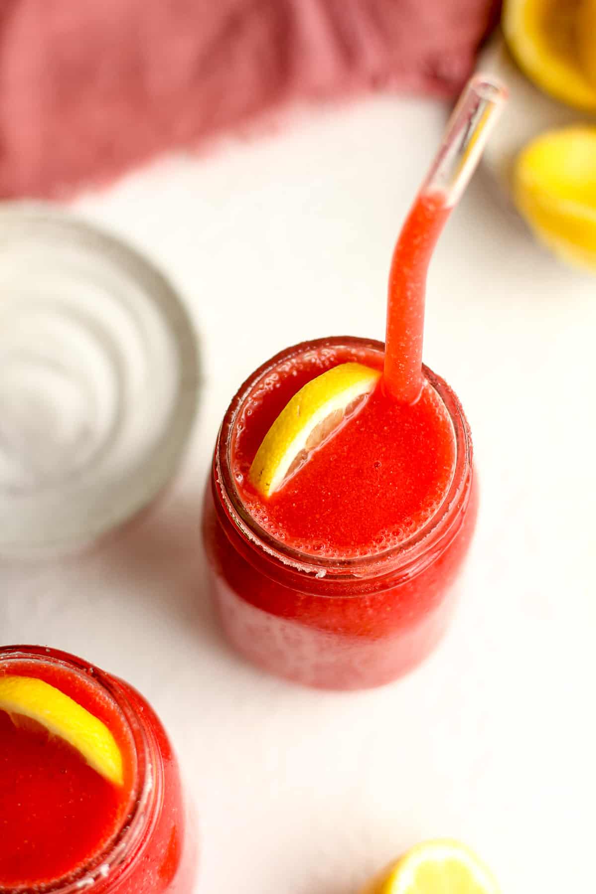 Overhead shot of two jars of strawberry vodka slashes.