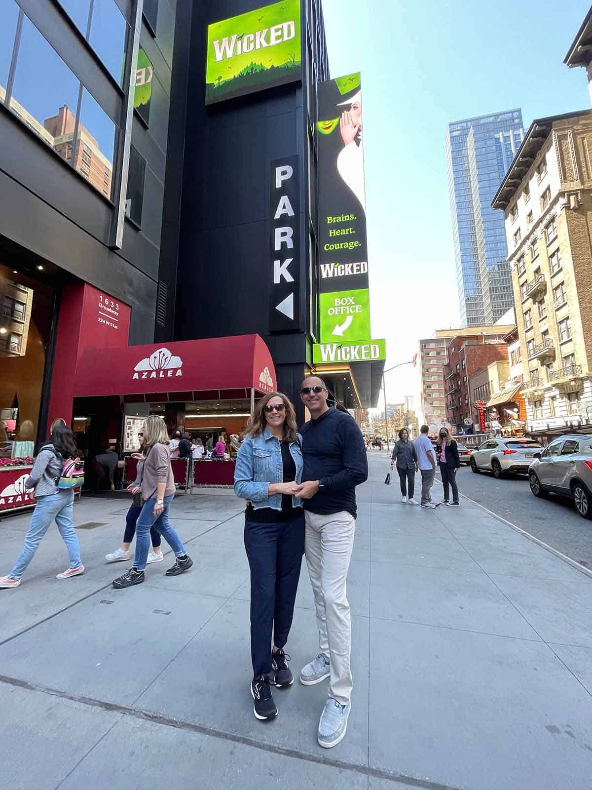 Sue and Mike standing in front of the Wicked theatre.