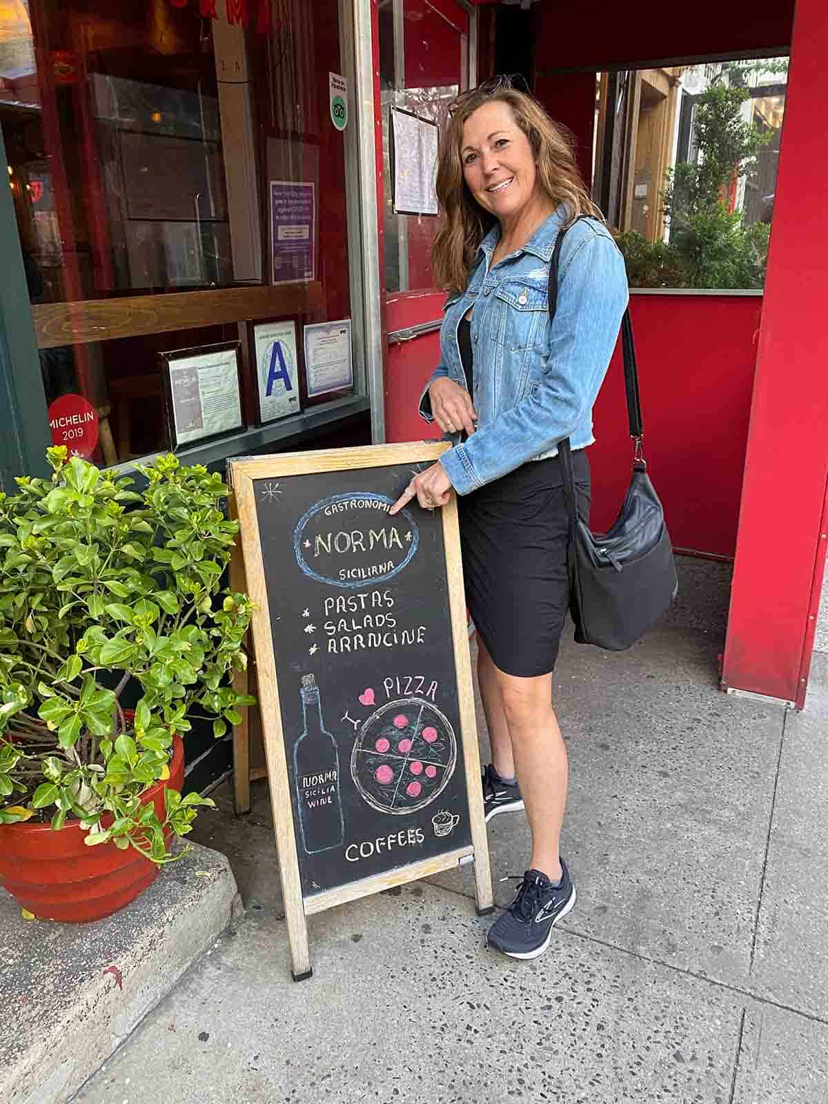 Me standing in front of a sign for Norma restaurant.