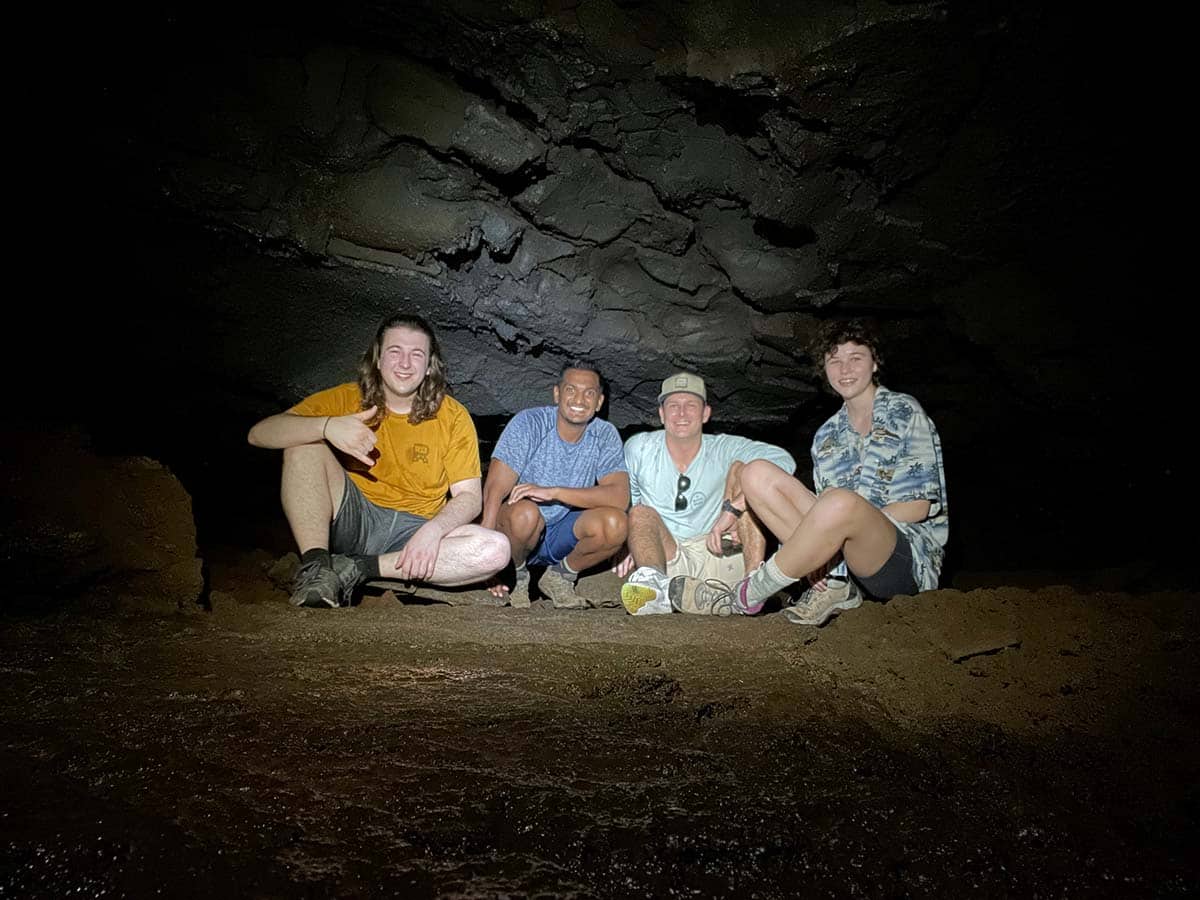 Zach and Kirsten and two others in a cave on the Big Island.