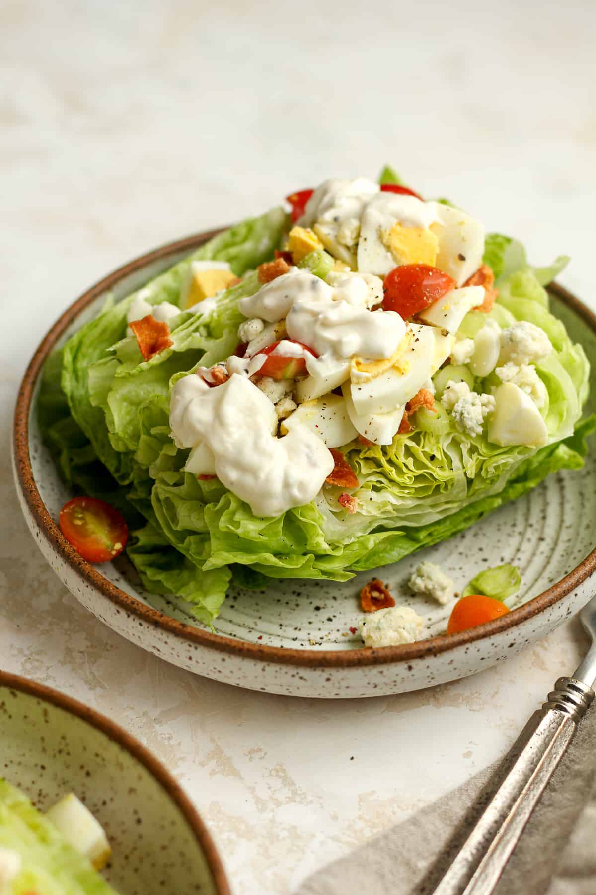 Side view of a classic wedge salad with dressing.