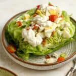 A bowl of wedge salad with blue cheese dressing.