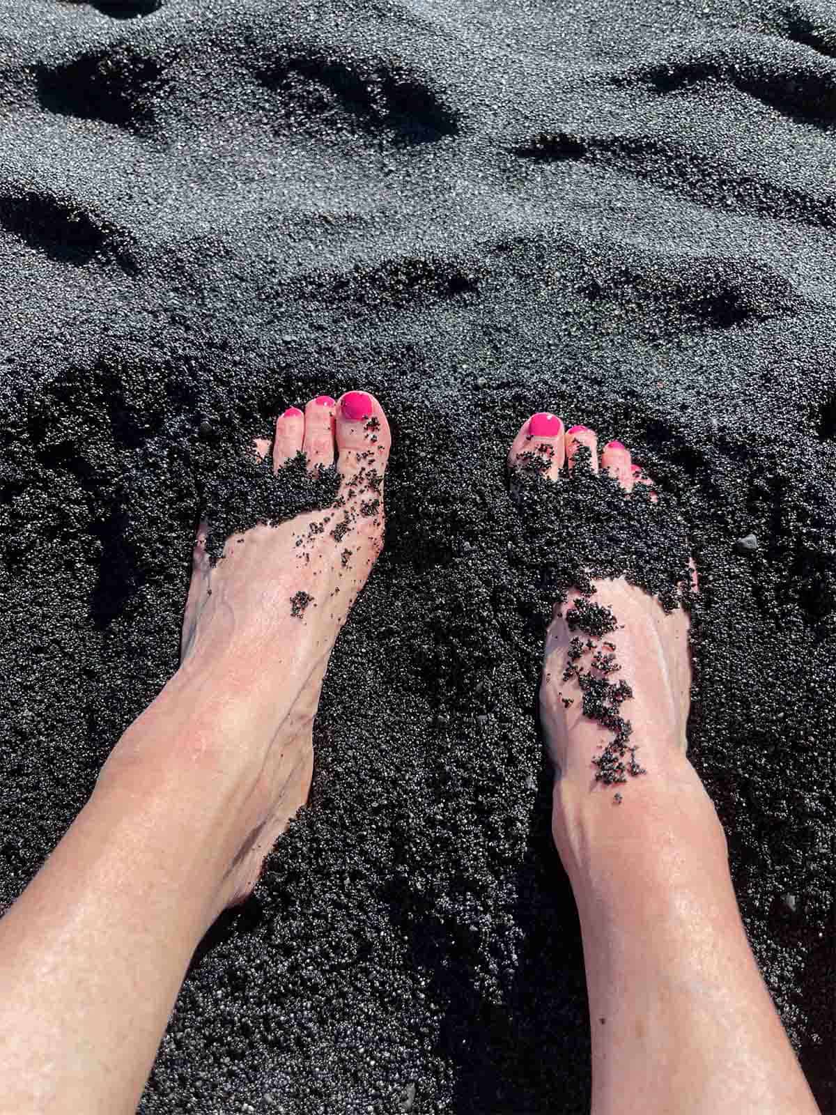 My feet in the black sand.