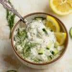 A bowl of healthy Tzatziki Sauce with fresh lemon and mint.