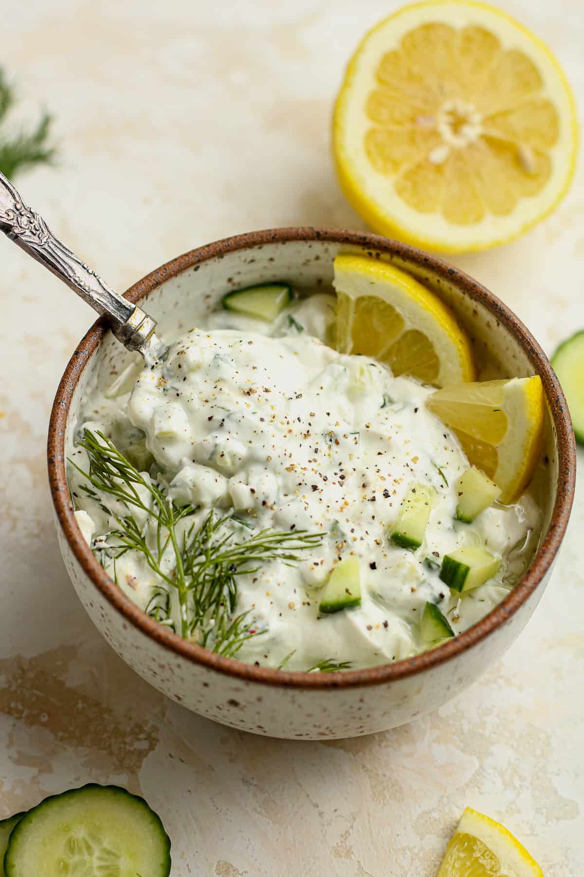 Side view of some homemade tzatziki sauce with a tablespoon.