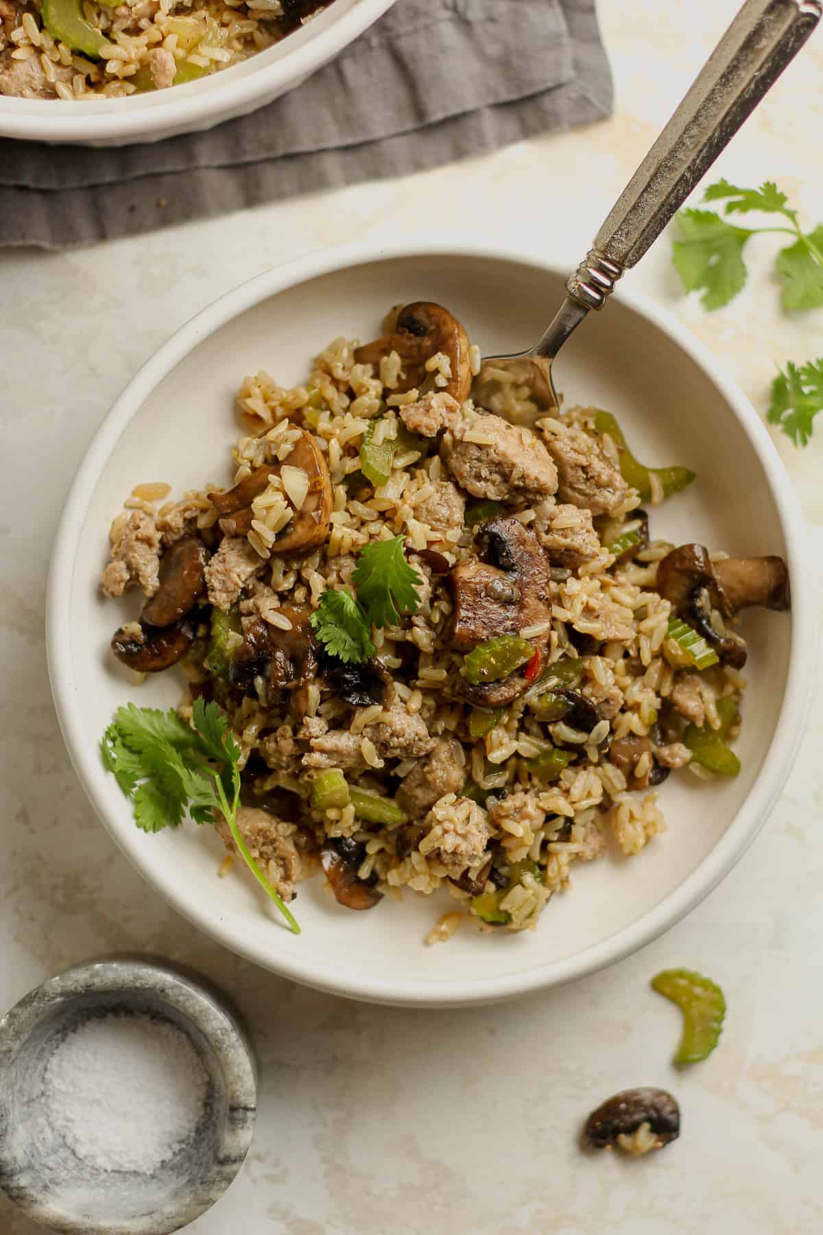 Overhead shot of a serving of rice dressing with mushrooms and sausage.