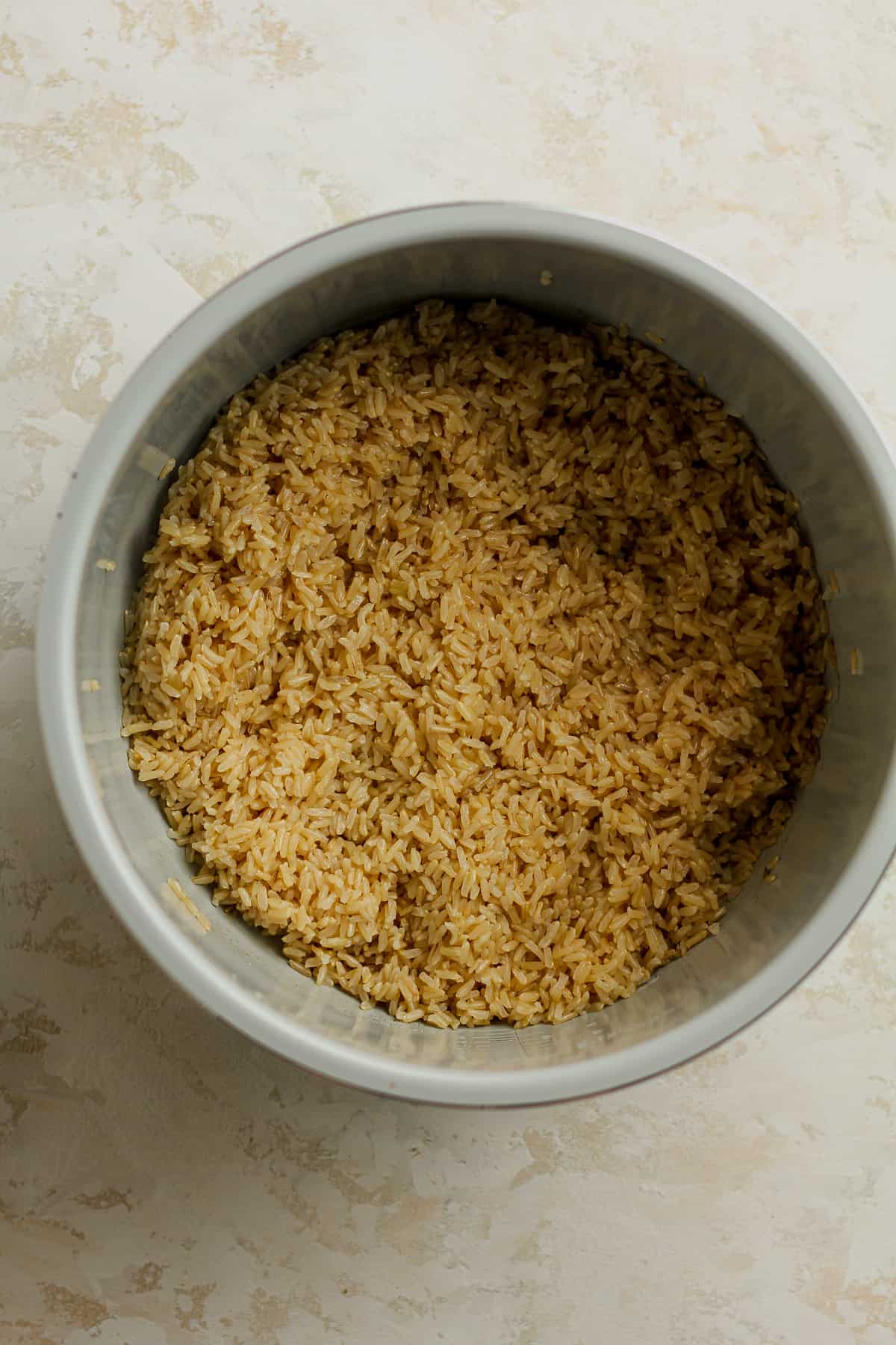 An instant pot bowl with the cooked brown rice.
