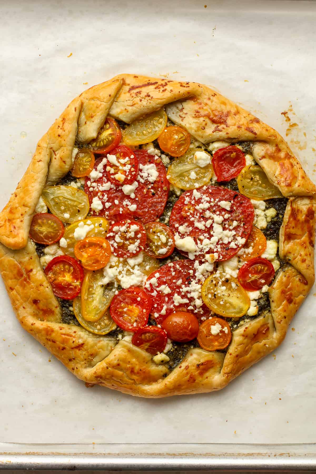 A just baked tomato galette on a pan.