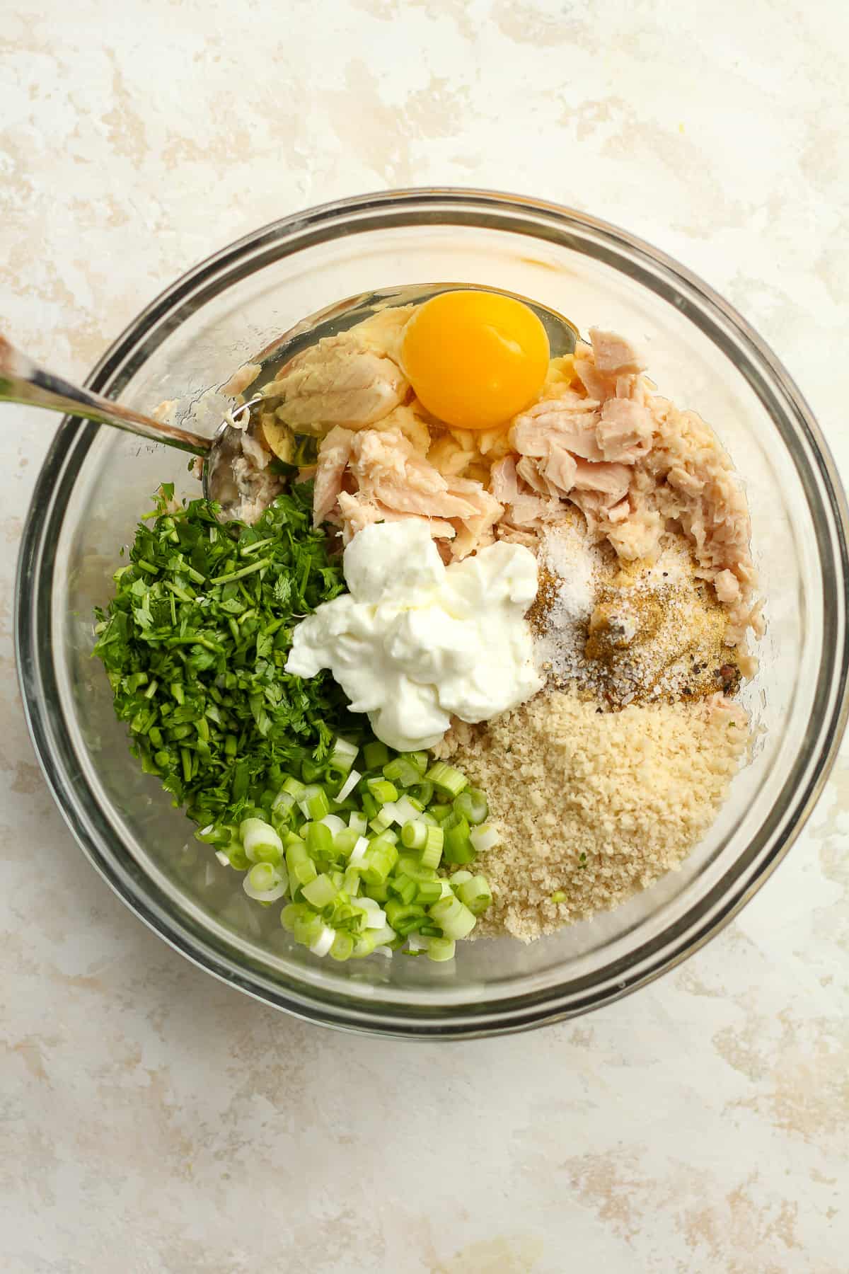 A bowl of the tuna cake ingredients, separated.