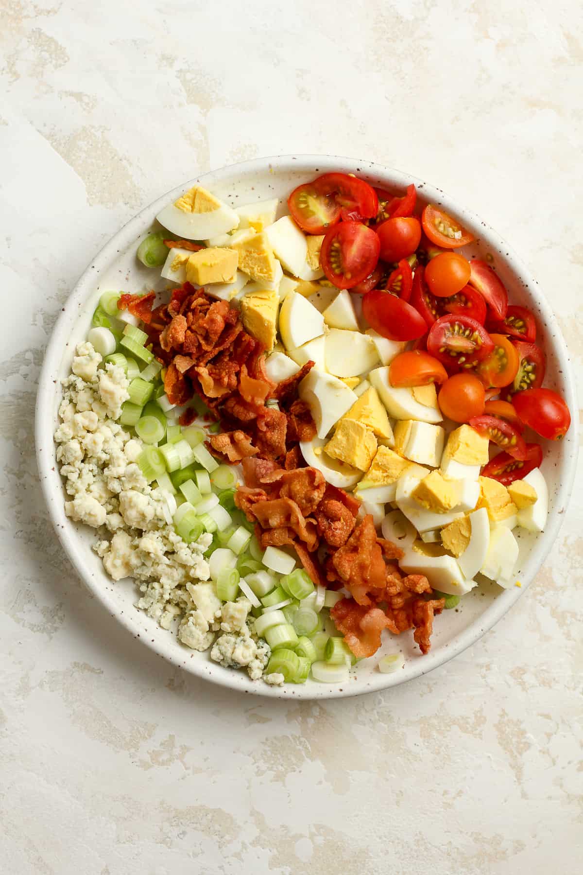 A bowl of the wedge salad toppings, by ingredient.
