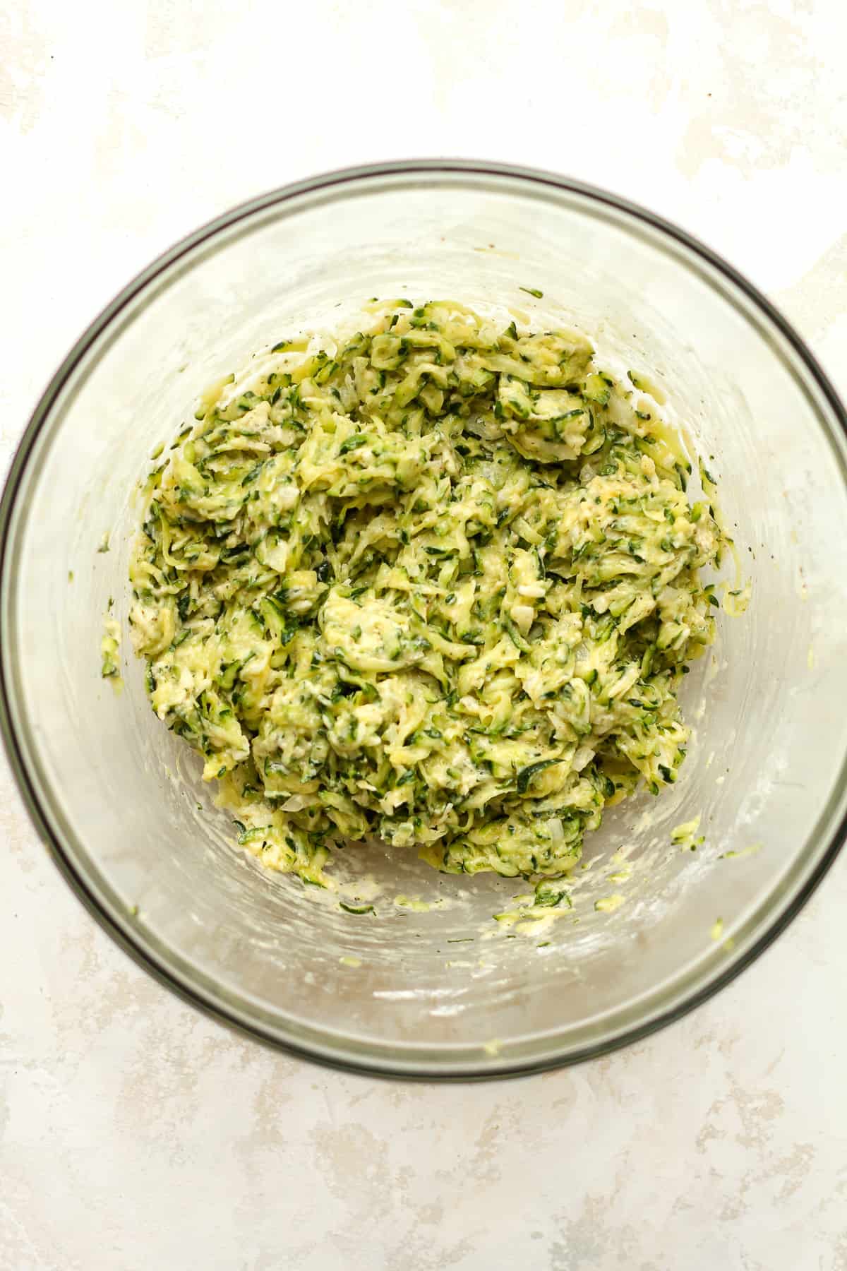 A bowl of the zucchini fritter mixture.