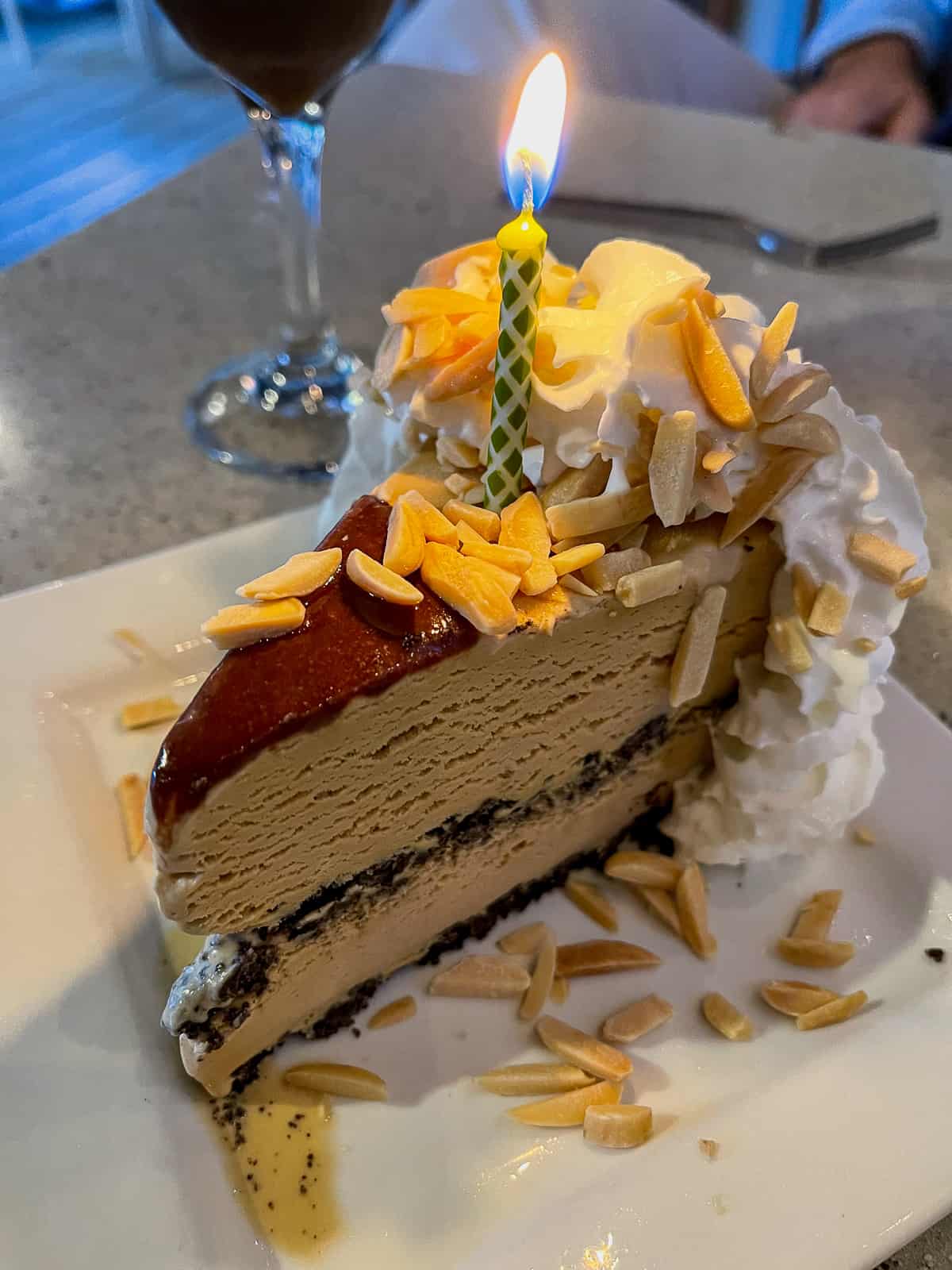 A slice of mud cake with a candle.